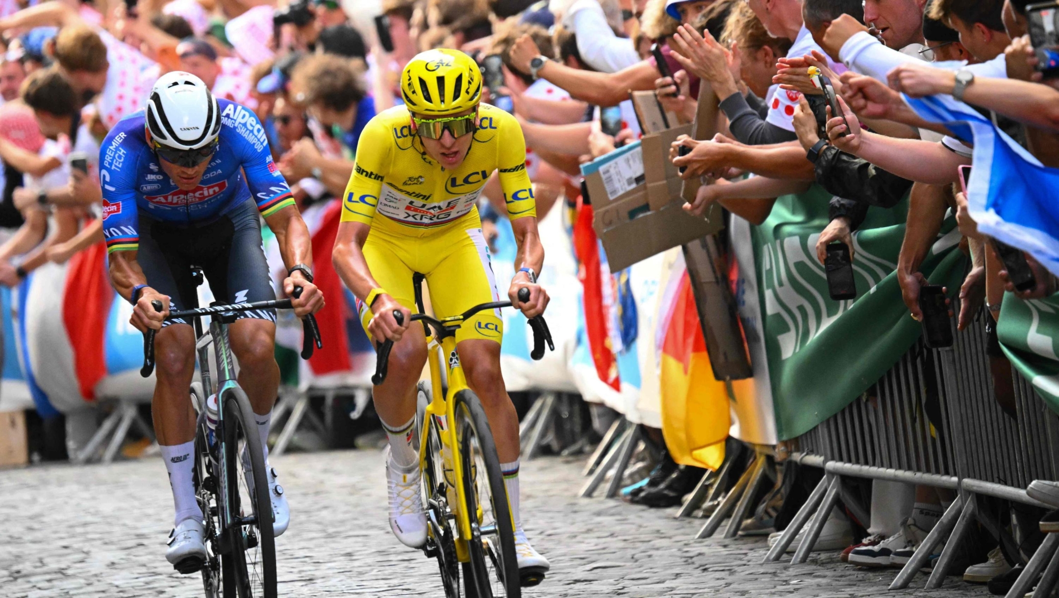 UAE Team Emirates - XRG's Slovenian rider Tadej Pogacar wearing the overall leader's yellow jersey and Alpecin - Premier Tech team's Dutch rider Mathieu van der Poel cycle on the Butte de Montmartre during the 21st stage of the 113th edition of the Tour de France cycling race, 88,7 km starting and finishing in Paris, on July 26, 2026. (Photo by Etienne GARNIER / POOL / AFP)