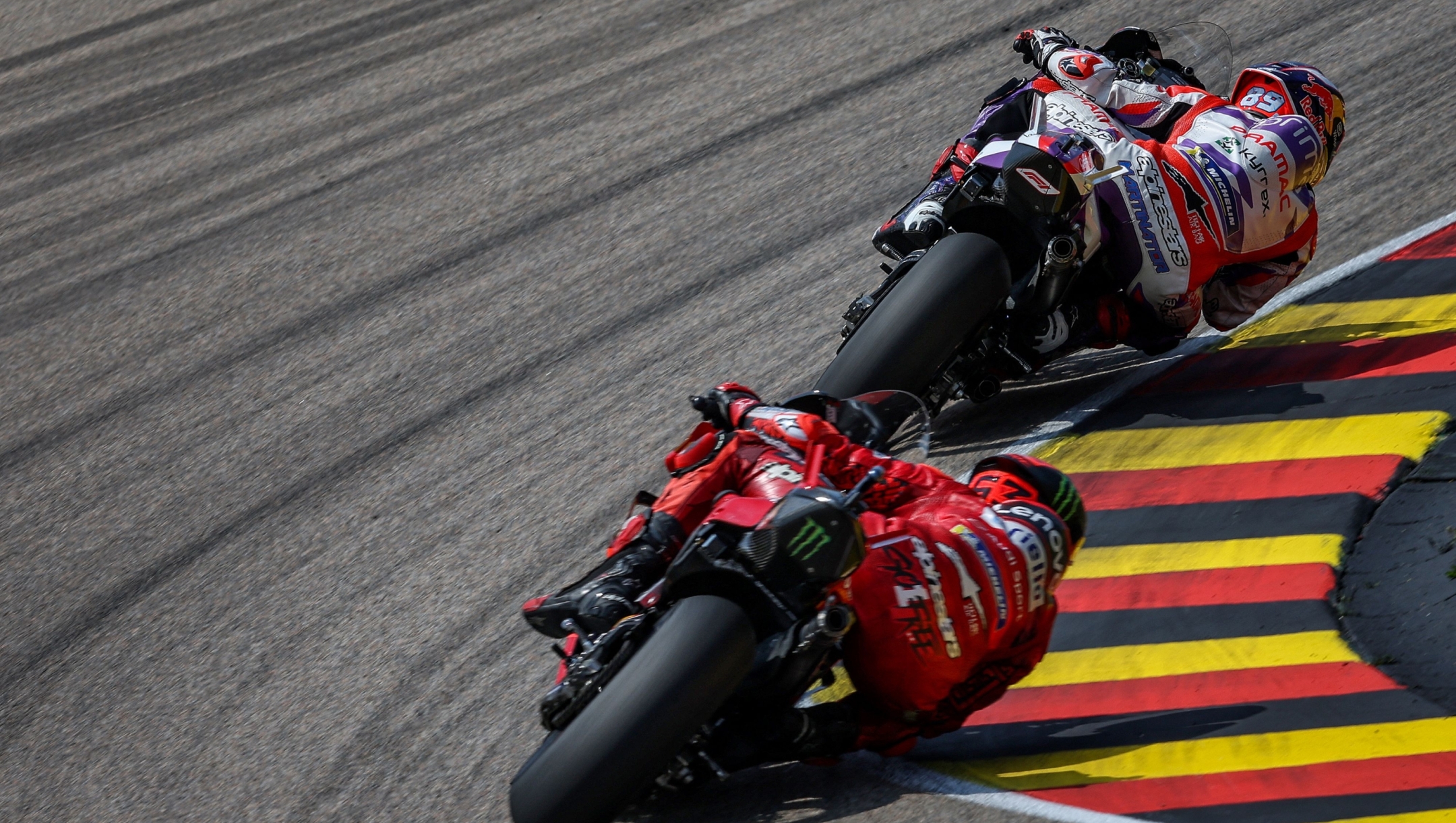 Winner Ducati Pramac Racing Team's Spanish rider Jorge Martin (R) and second-placed Ducati Lenovo Team's Italian rider Francesco Bagnaia compete in the MotoGP German motorcycle Grand Prix at the Sachsenring racing circuit in Hohenstein-Ernstthal near Chemnitz, eastern Germany, on June 18, 2023. (Photo by Ronny Hartmann / AFP)