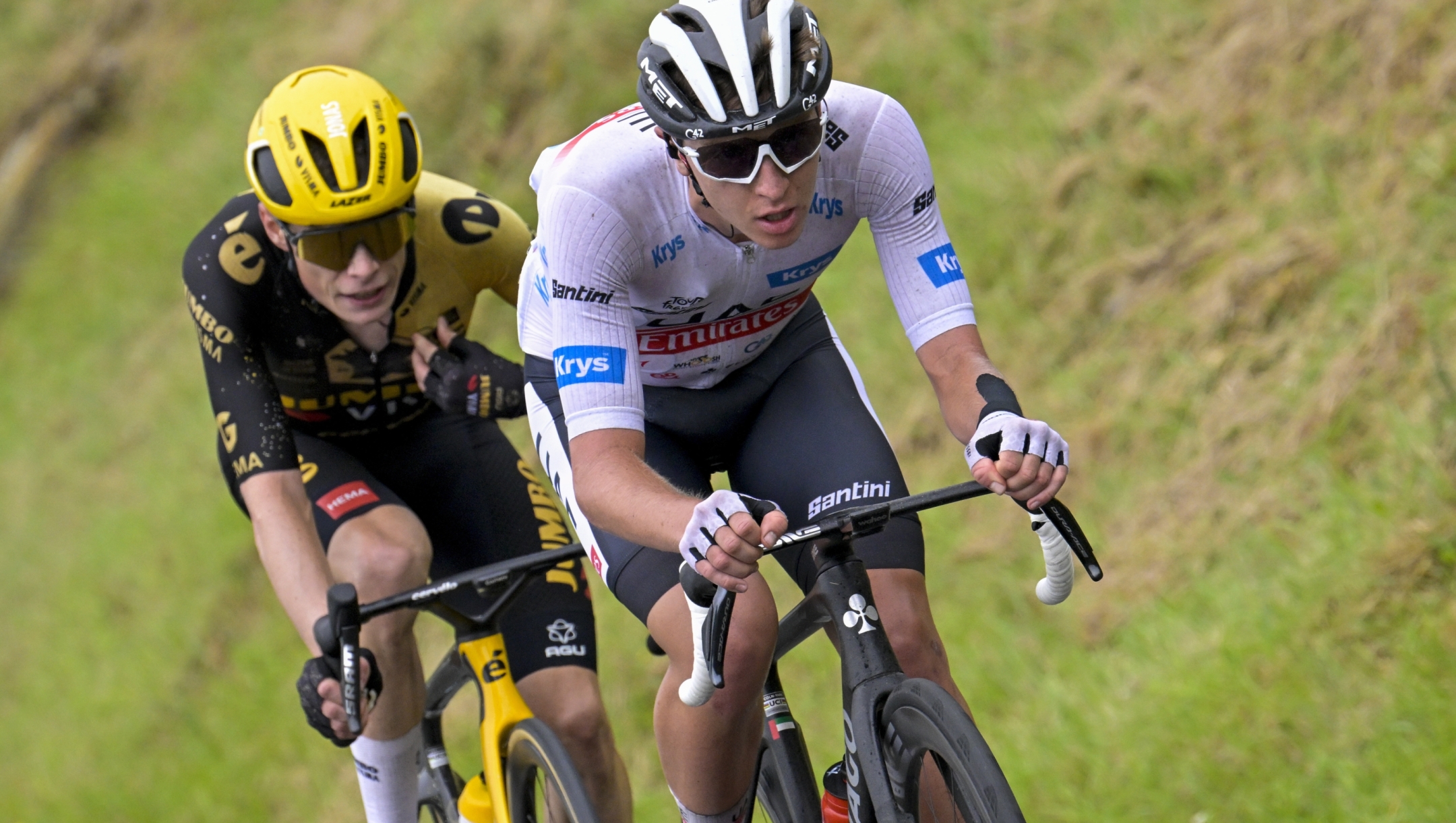 Denmark's Jonas Vingegaard, left, follows Slovenia's Tadej Pogacar, wearing the best young rider's white jersey, during the second stage of the Tour de France cycling race over 209 kilometers (130 miles) with start in Vitoria-Gasteiz and finish in San Sebastian, Spain, Sunday, July 2, 2023. (Bernard Papon/Pool Photo via AP)