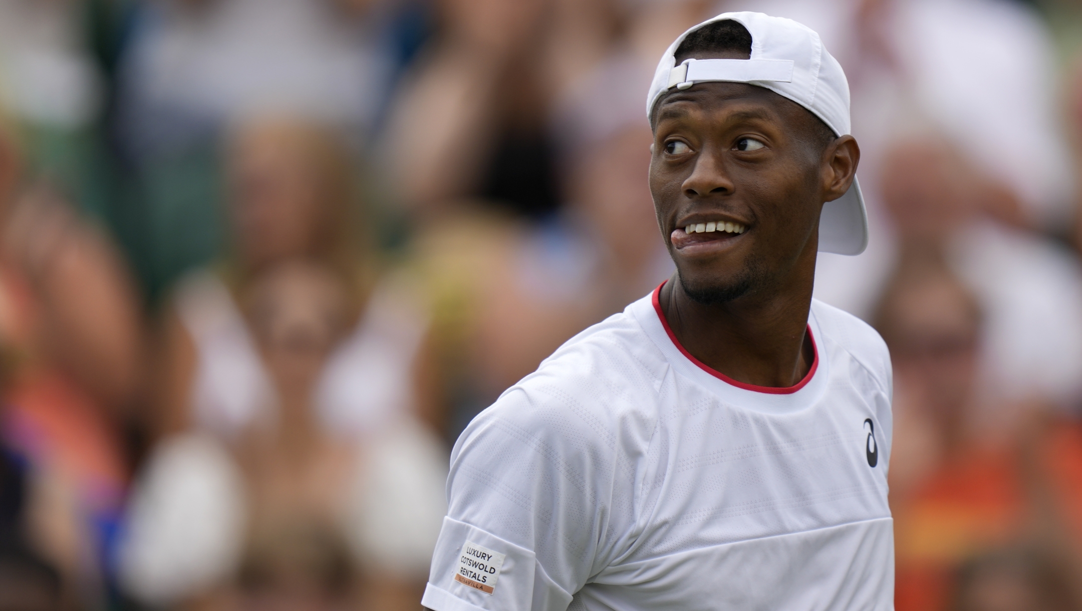 Christopher Eubanks of the US reacts as he plays Stefanos Tsitsipas of Greece in a men's singles match on day eight of the Wimbledon tennis championships in London, Monday, July 10, 2023. (AP Photo/Alastair Grant)