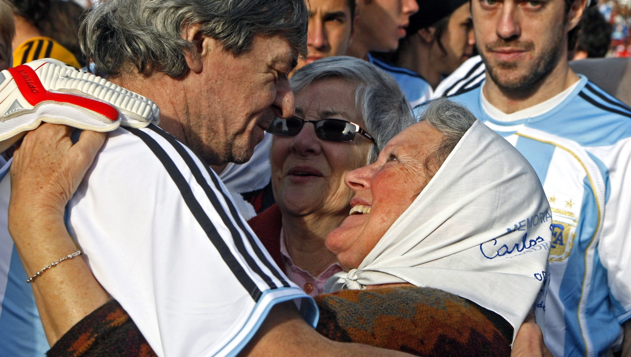 Former football player of the 1978 Argentinian national team, Rene Houseman (L), embraces member of the Human Rights organization Madres de Plaza de Mayo, Nora Cortinas (R), before a match called "the other final" on June 29, 2008 at River Plate's stadium in Buenos Aires. The match was held in the framework of the 30th anniversary of their FIFA World Cup 1978 which final was played at River Plate' s stadium, only some blocks away of the Army School of Mechanics (ESMA), a former clandestine center of detention during the last military dictatorship (1976-1983) in Argentina. The Cup was given to the Argentine team by dictator (1976-1981) Jorge Rafael Videla, and "the other match" is an attempt to dissociate the player' s performance with the authoritarian regime and a recognition to the victims of the dictatorship. AFP PHOTO / ALEJANDRO PAGNI