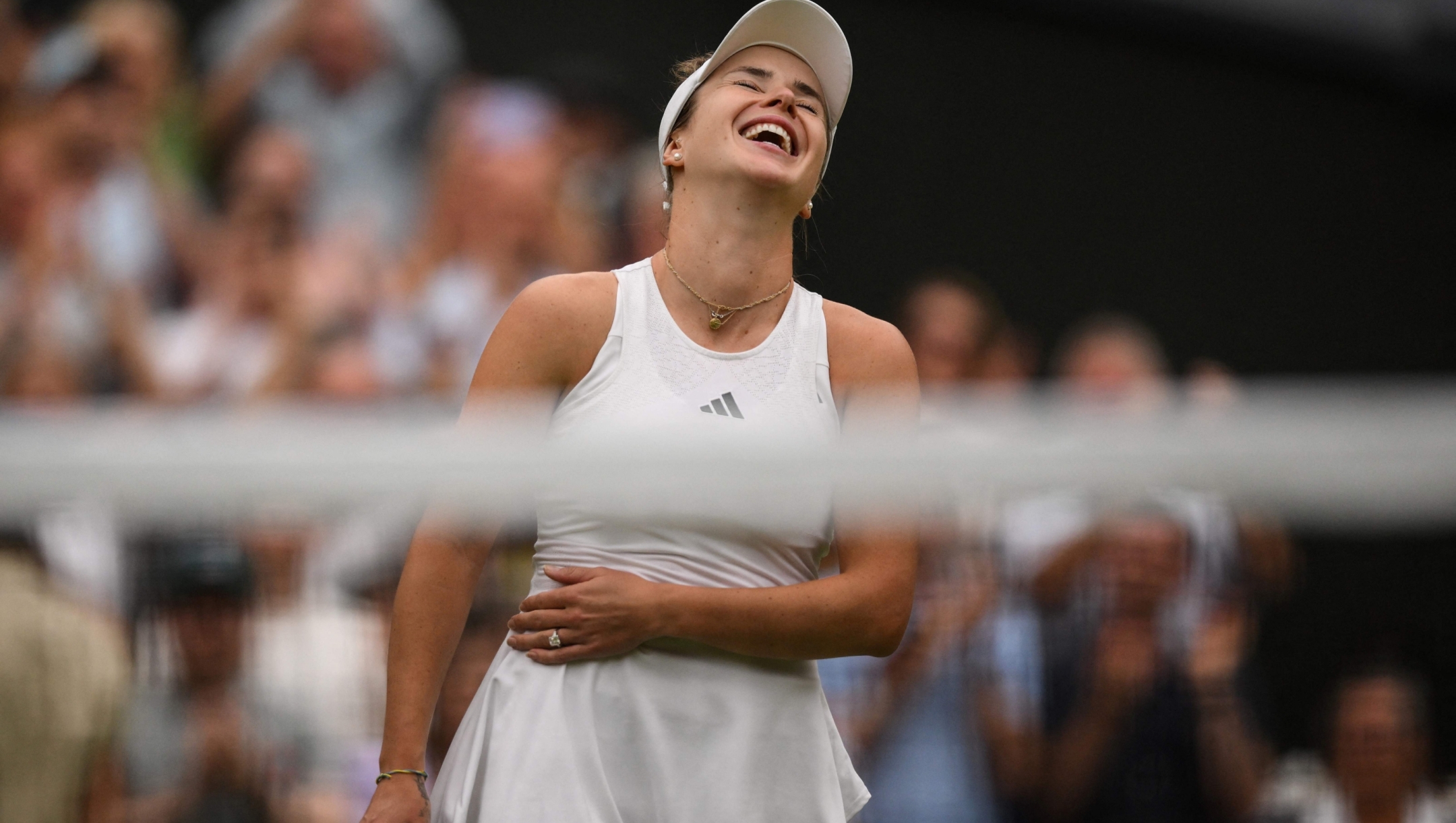 TOPSHOT - Ukraine's Elina Svitolina celebrates winning against Poland's Iga Swiatek during their women's singles quarter-finals tennis match on the ninth day of the 2023 Wimbledon Championships at The All England Tennis Club in Wimbledon, southwest London, on July 11, 2023. (Photo by Daniel LEAL / AFP) / RESTRICTED TO EDITORIAL USE