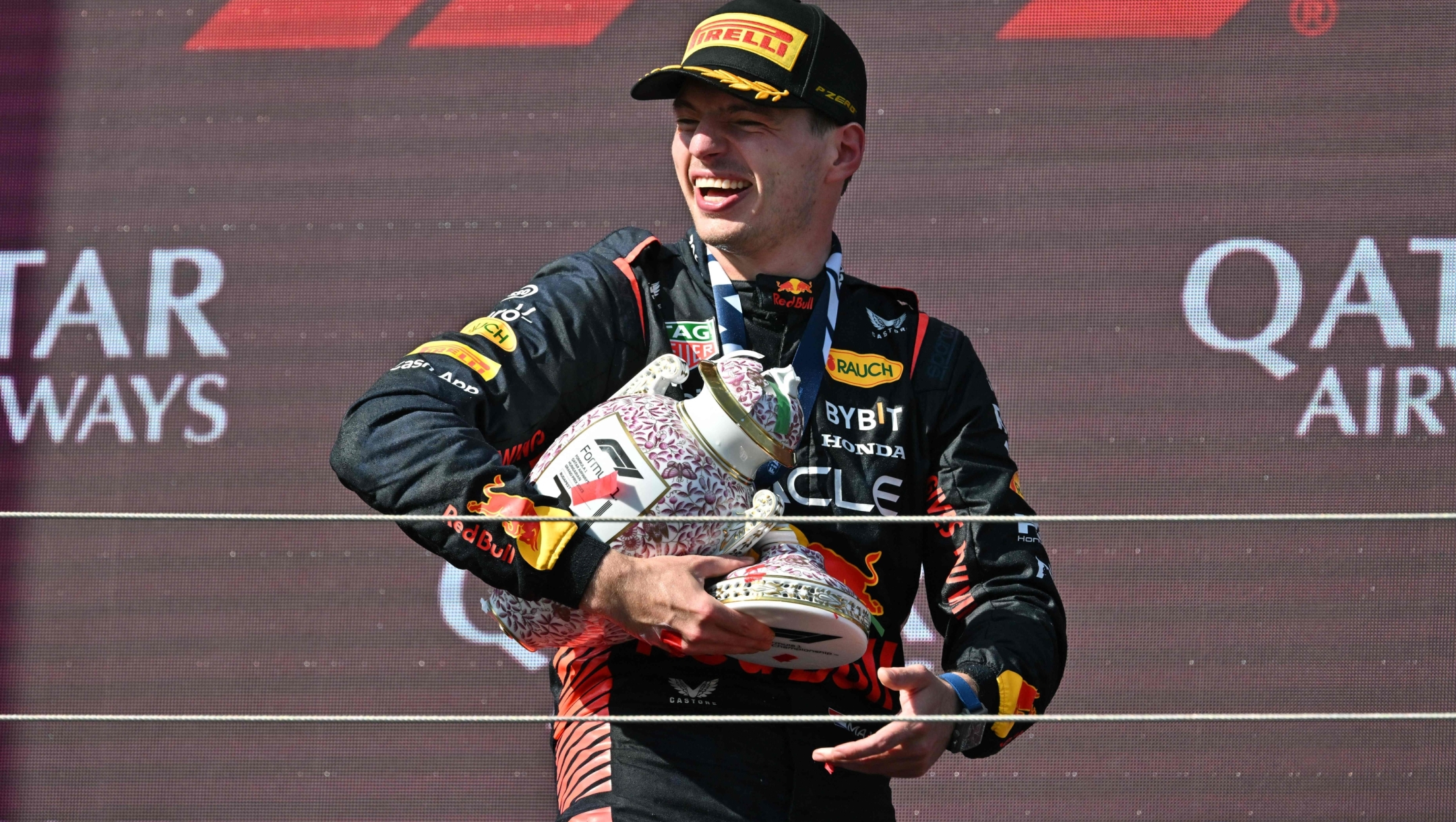 Winner Red Bull Racing's Dutch driver Max Verstappen leaves the podium with his broken trophy after the Formula One Hungarian Grand Prix at the Hungaroring race track in Mogyorod near Budapest on July 23, 2023. (Photo by ATTILA KISBENEDEK / AFP)