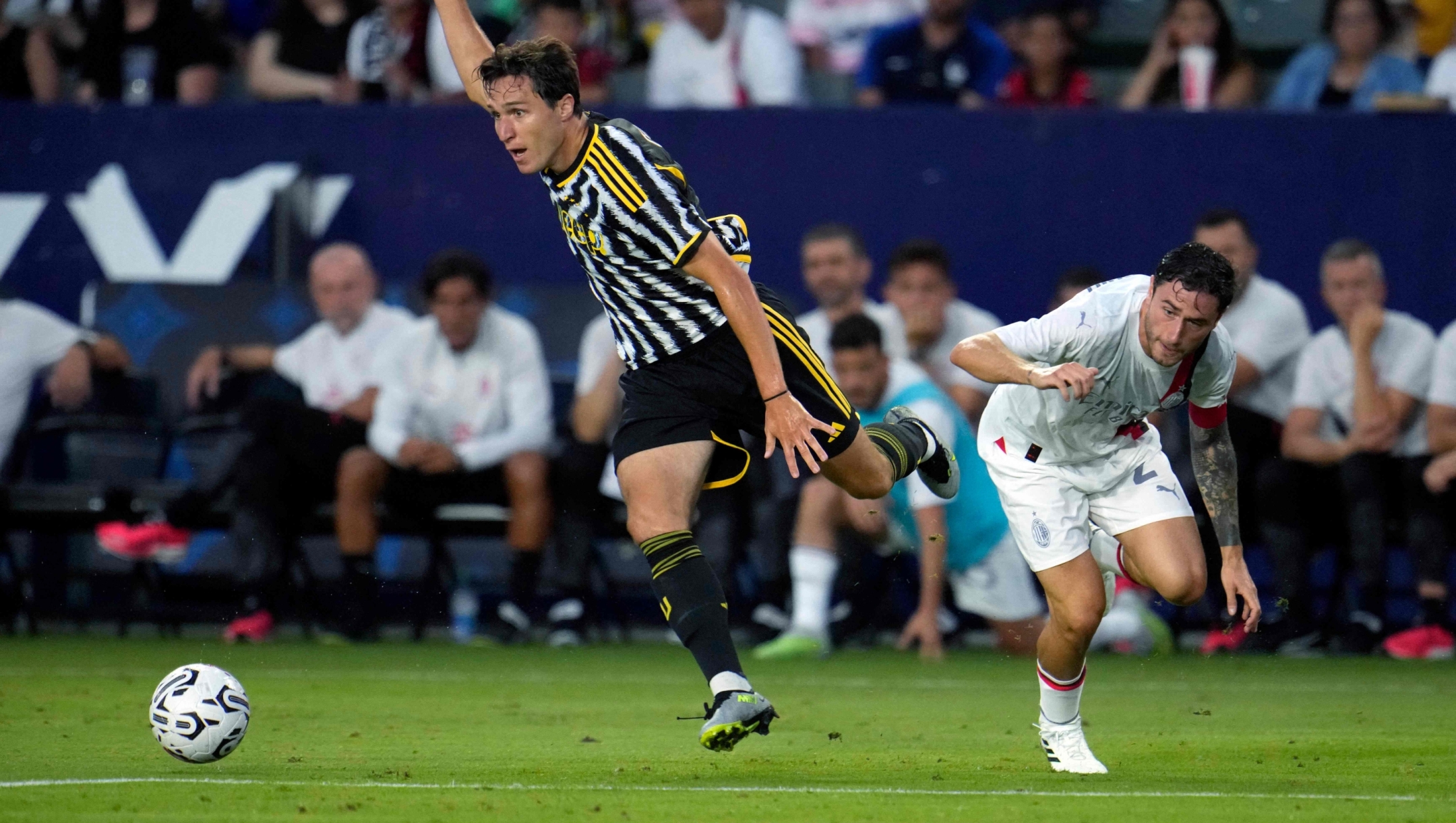 CARSON, CALIFORNIA - JULY 27: Federico Chiesa #7 of Juventus runs past a tackle by Davide Calabria #2 of Milan during the first half of the pre-season friendly match between Juventus and AC Milan at Dignity Health Sports Park on July 27, 2023 in Carson, California.   Kevork Djansezian/Getty Images/AFP (Photo by KEVORK DJANSEZIAN / GETTY IMAGES NORTH AMERICA / Getty Images via AFP)