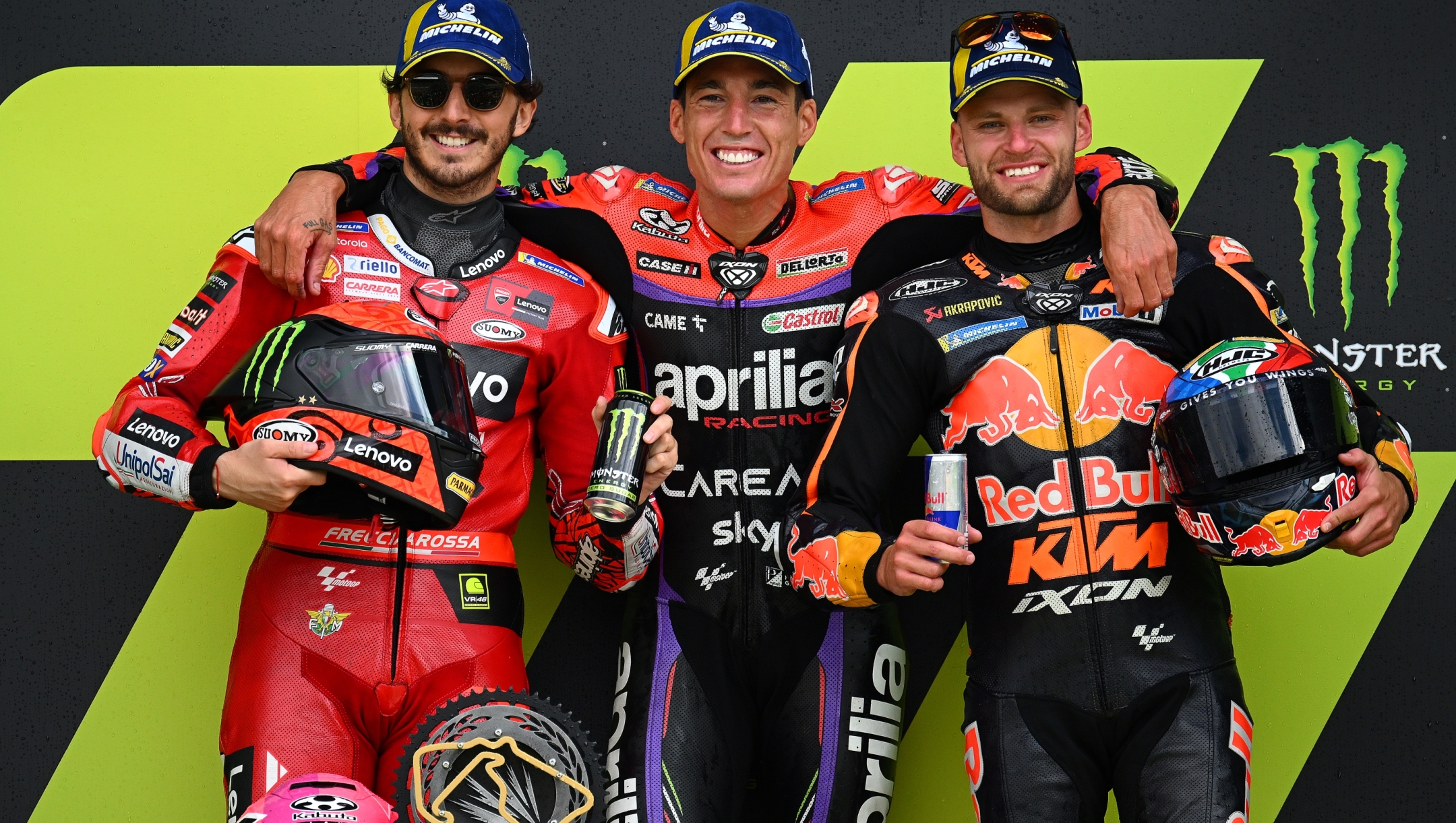 NORTHAMPTON, ENGLAND - AUGUST 06: (Left To Right) Francesco Bagnaia of Italy, second placed rider, Aleix Espargaro of Spain, race winner and Brad Binder of South Africa, third placed rider celebrate on the podium after the MotoGP of Great Britain - Race at Silverstone Circuit on August 06, 2023 in Northampton, England. (Photo by Clive Mason/Getty Images)