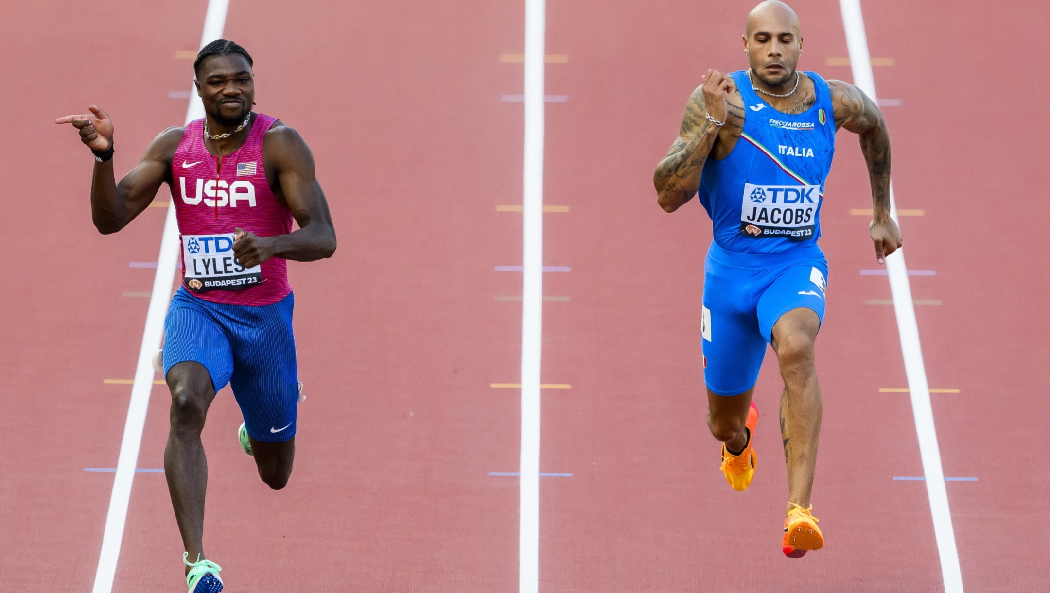 epa10810038 Noah Lyles (L) of the USA in action next to Lamont Marcell Jacobs of Italy during the men's 100 meters semi-final of the World Athletics Championships in Budapest, Hungary, 20 August 2023.  EPA/JEAN-CHRISTOPHE BOTT