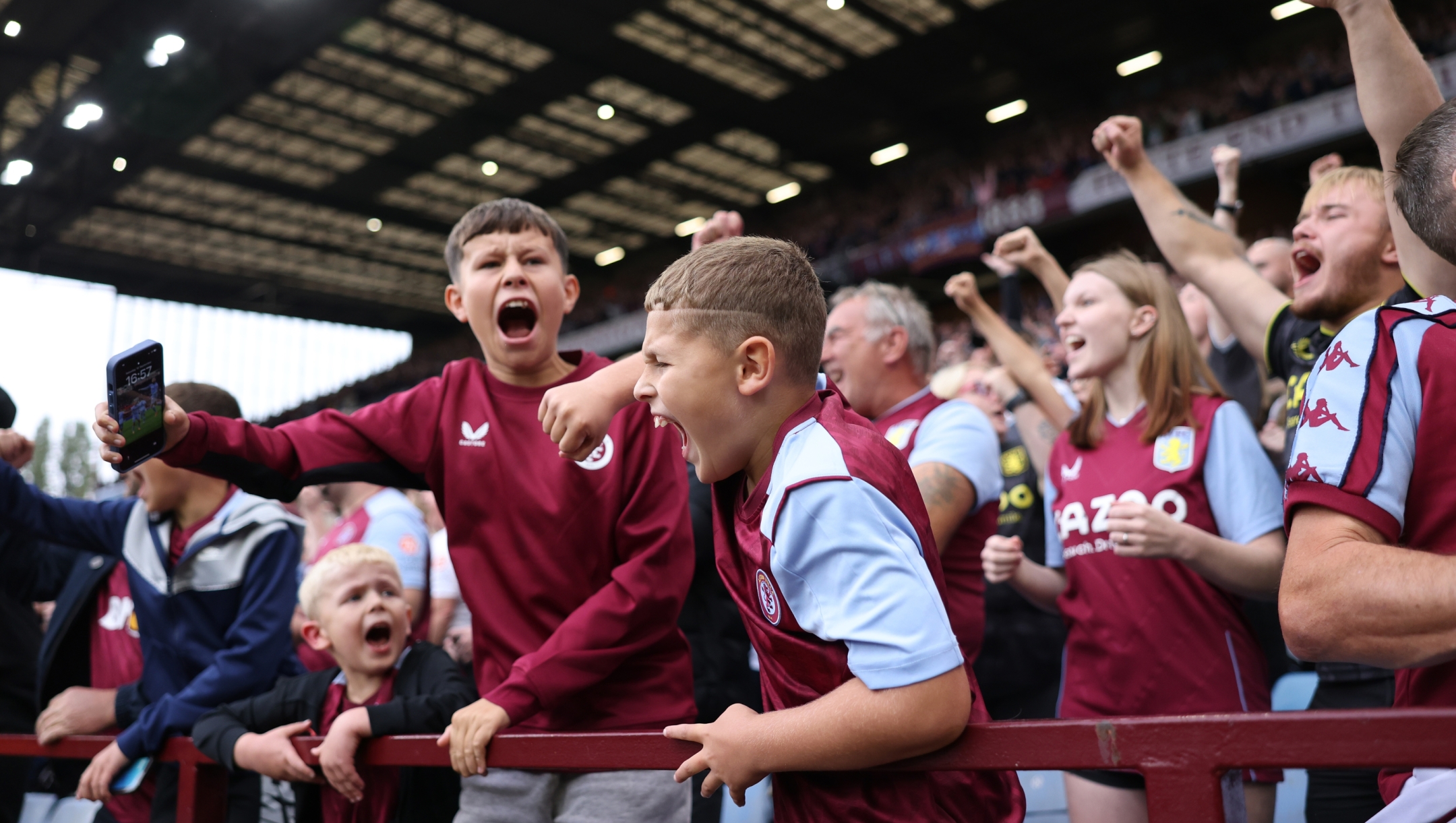 BIRMINGHAM, ENGLAND - SEPTEMBER 16: Young fans of Aston Vill celebrate during the Premier League match between Aston Villa and Crystal Palace at Villa Park on September 16, 2023 in Birmingham, England. (Photo by Matthew Lewis/Getty Images)