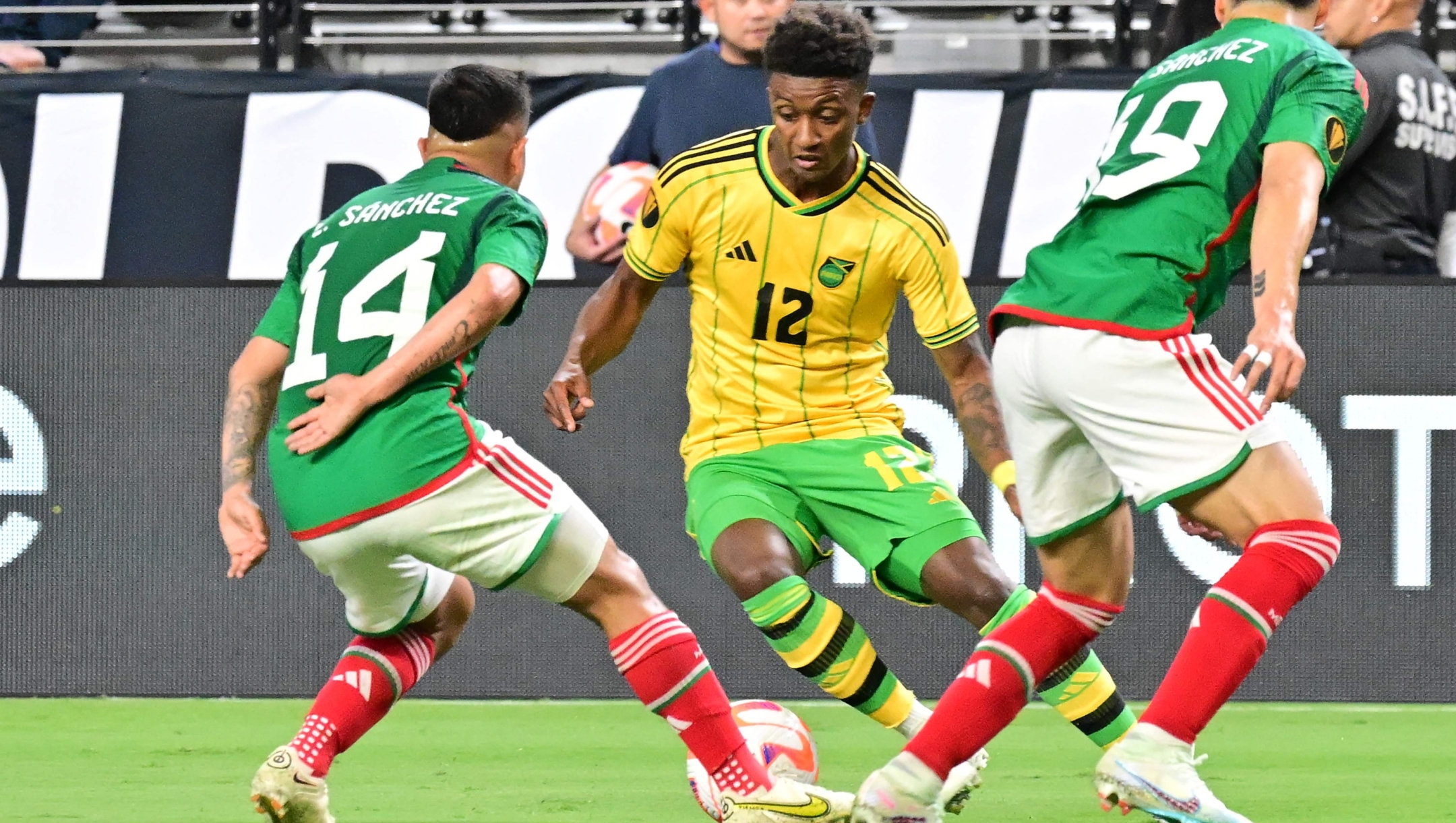 Jamaica's forward Demarai Gray (C) fights for the ball with Mexico's forward Erick Sanchez (R) and Mexico's defender Jorge Sanchez (R) during the Concacaf 2023 Gold Cup semifinal football match between Mexico and Jamaica at Allegiant Stadium in Las Vegas, Nevada on July 12, 2023. (Photo by Frederic J. BROWN / AFP)