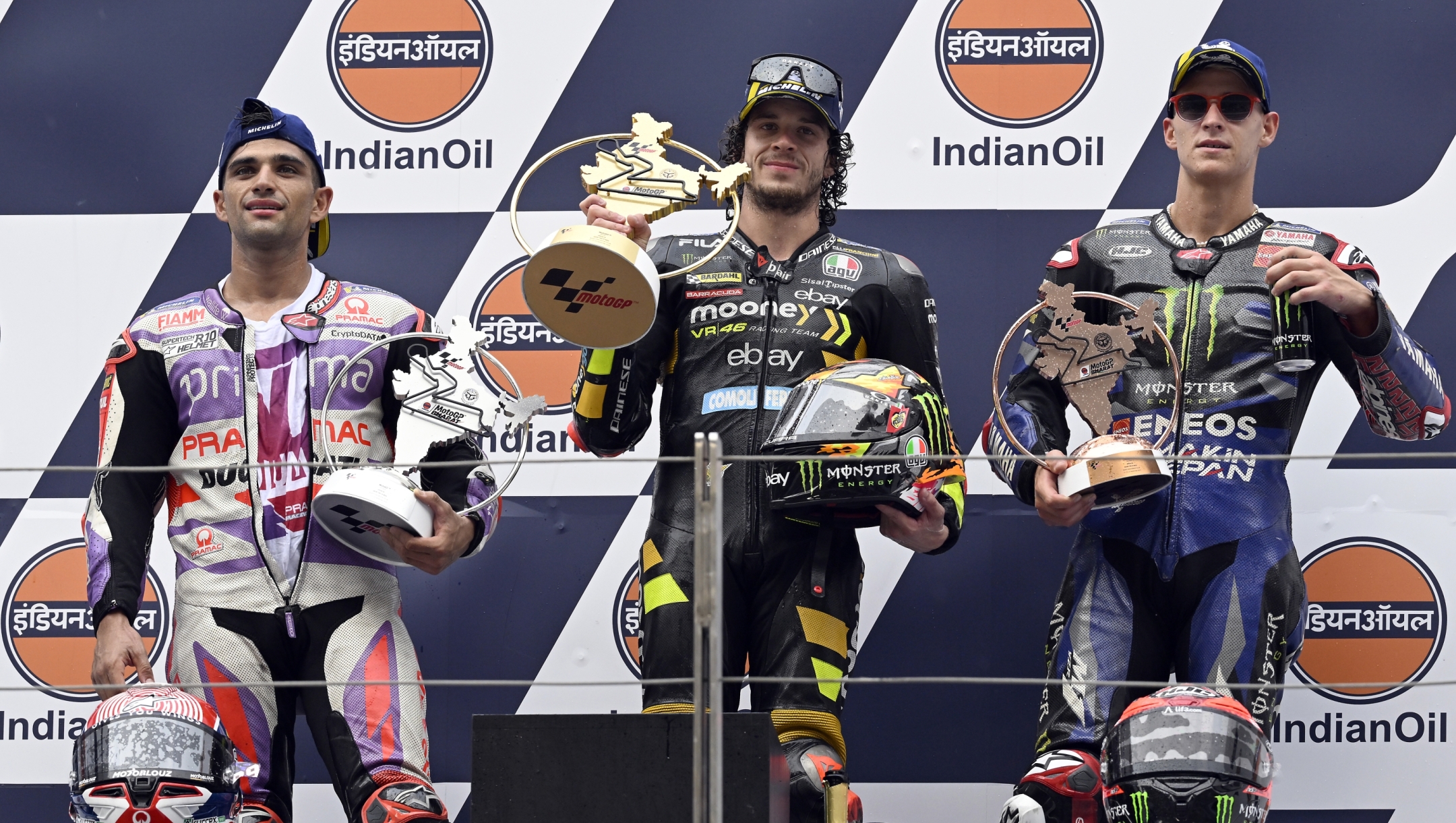DELHI, INDIA - SEPTEMBER 24: Jorge Martin of Spain and Prima Pramac Racing team (L, second place), Marco Bezzecchi of Italy and  Mooney VR46 Racing Team (C, First place) and Fabio Quartararo of France and Monster Energy Yamaha team (R, third place) pose for media on podium after MotoGP race of the Indian MotoGP Grand Prix at the Buddh International Circuit in Greater Noida on the outskirts of New Delhi, on September 24, 2023. (Photo by Prakash Singh/Getty Images)