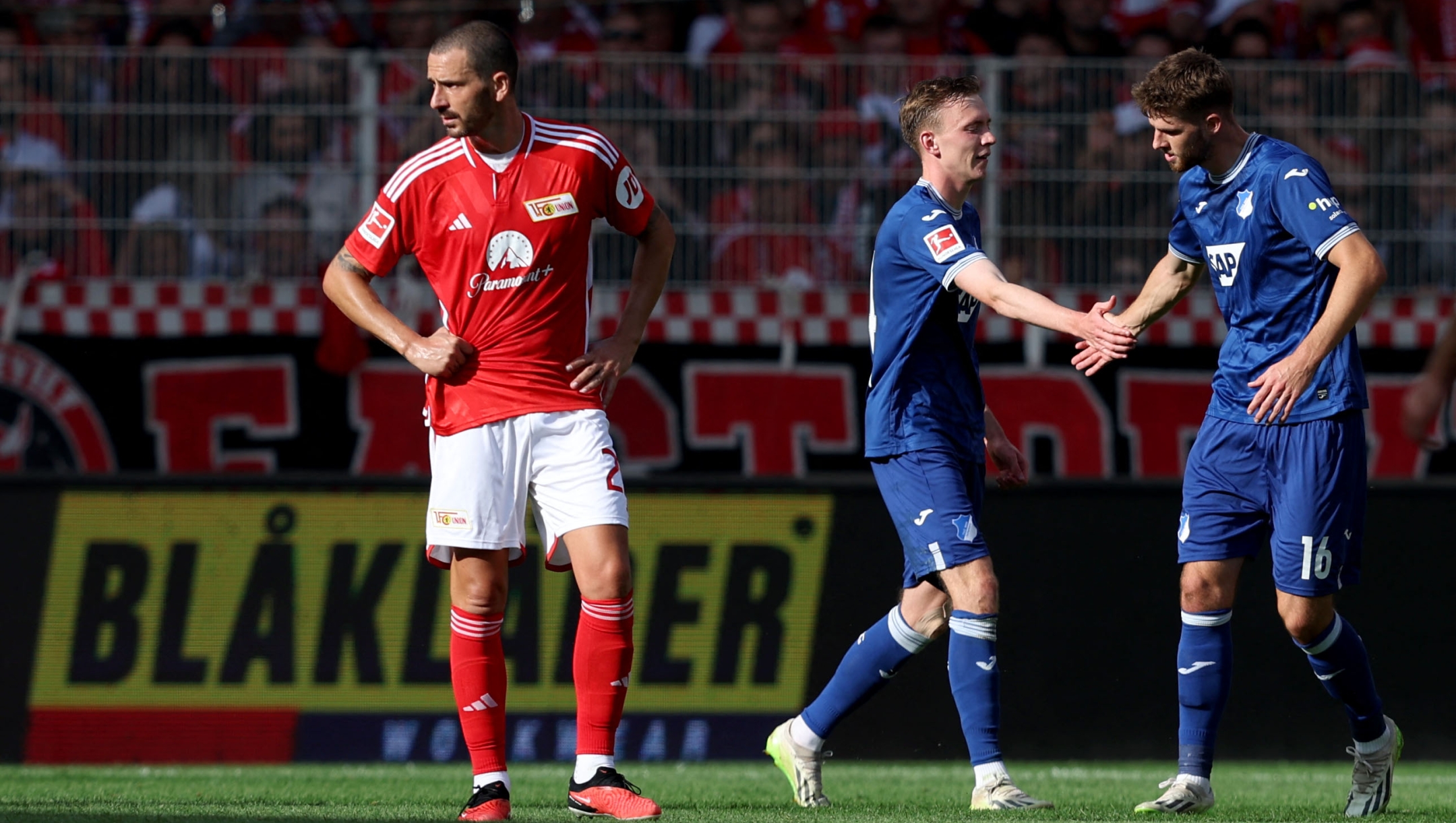 Hoffenheim's German forward #14 Maximilian Beier (C) celebrates after scoring the 0-2 goal with Hoffenheim's German midfielder Anton Stach (R) as Union Berlin's Italian defender #23 Leonardo Bonucci (L) looks on during the German first division Bundesliga football match between Union Berlin and TSG 1899 Hoffenheim in Berlin, Germany, on September 23, 2023. (Photo by Ronny HARTMANN / AFP) / DFL REGULATIONS PROHIBIT ANY USE OF PHOTOGRAPHS AS IMAGE SEQUENCES AND/OR QUASI-VIDEO