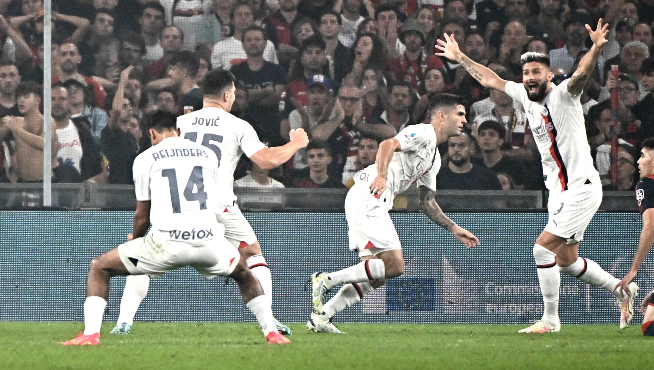 Milan's Christian Pulisic (L) jubilates with his teammates after scoring the gol during the Italian Serie A match, Genoa CFC vs Ac Milan at Luigi Ferraris stadium in Genoa, Italy, 07 october 2023. ANSA/LUCA ZENNARO