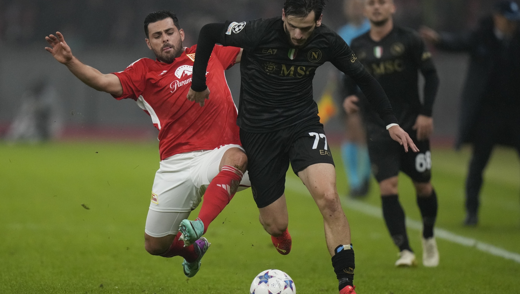 Union's Kevin Volland, left, and Napoli's Khvicha Kvaratskhelia vie for the ball during the group C Champions League soccer match between Union Berlin and Napoli, at the Olympiastadion in Berlin, Germany, Tuesday, Oct. 24, 2023. (AP Photo/Matthias Schrader)