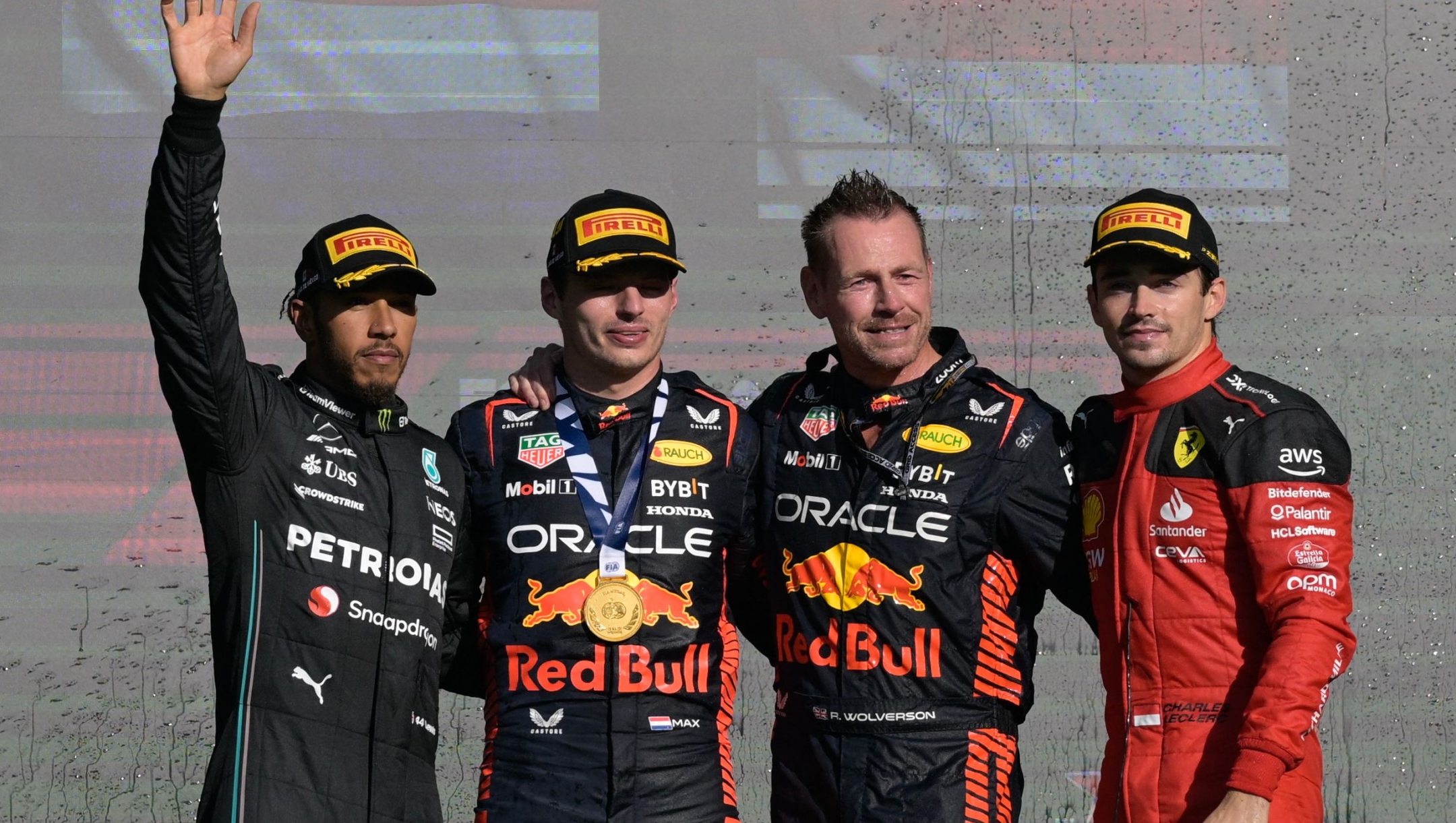 (L to R) Mercedes' British driver Lewis Hamilton, Red Bull Racing's Dutch driver Max Verstappen, Red Bull Racing's British team member Richard Wholverson, and Ferrari's Monegasque driver Charles Leclerc celebrate on the podium after the Formula One Mexico Grand Prix at the Hermanos Rodriguez racetrack in Mexico City on October 29, 2023. Verstappen won the race, Hamilton finished second while Leclerc placed third. (Photo by Alfredo ESTRELLA / AFP)