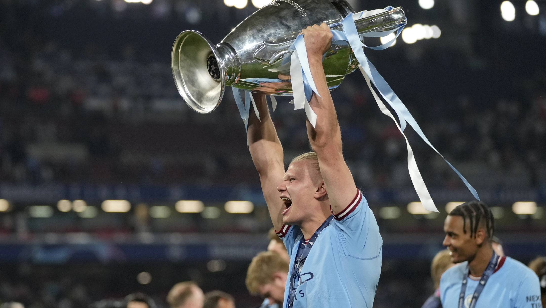 Manchester City's Erling Haaland celebrates with the trophy after winning the Champions League final soccer match between Manchester City and Inter Milan at the Ataturk Olympic Stadium in Istanbul, Turkey, Sunday, June 11, 2023. Manchester City won 1-0. (AP Photo/Francisco Seco)