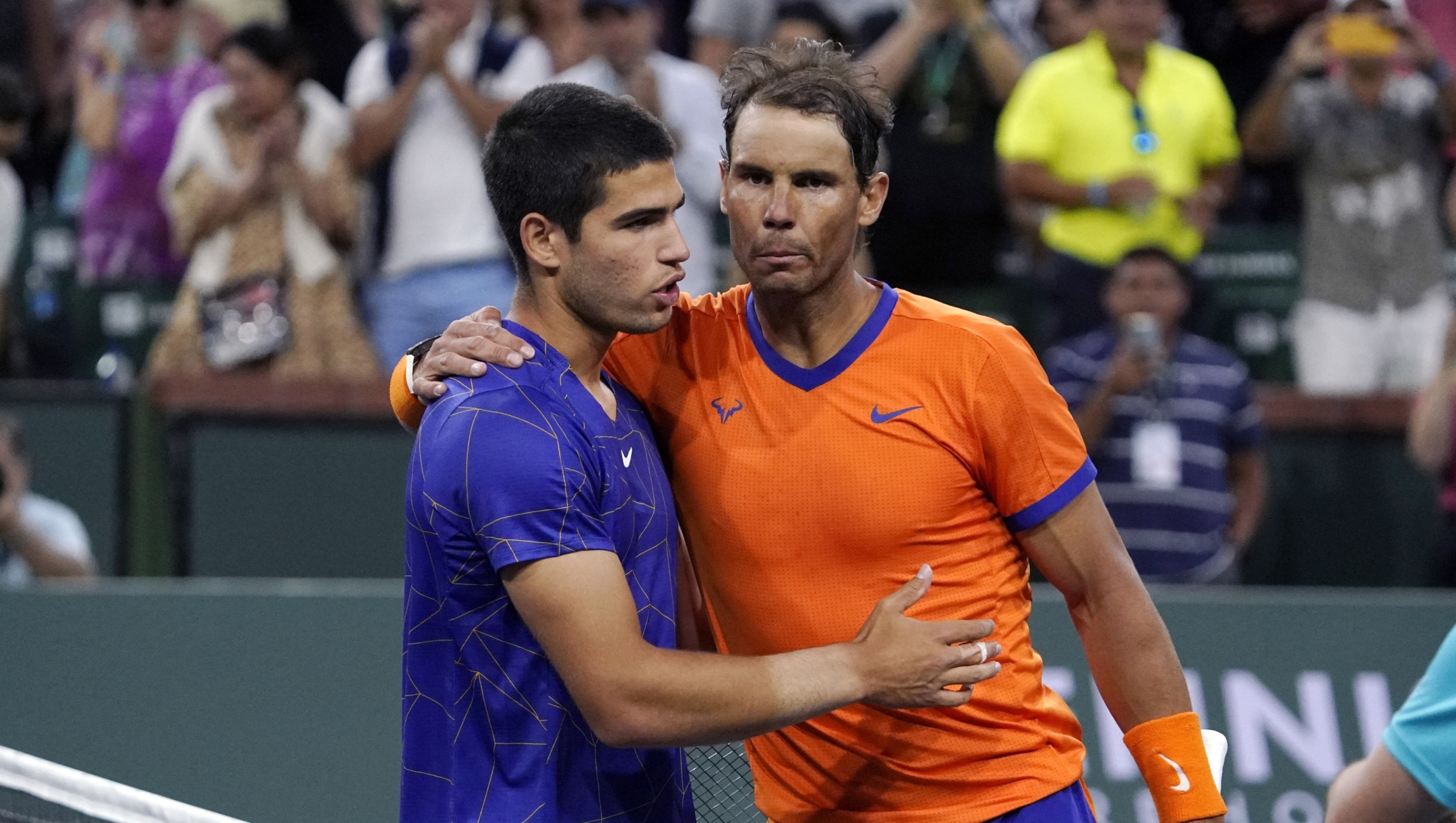 FILE - Rafael Nadal, of Spain, right, greets compatriot Carlos Alcaraz after defeating him in the men's singles semifinals at the BNP Paribas Open tennis tournament Saturday, March 19, 2022, in Indian Wells, Calif. Teenager Carlos Alcaraz is the youngest year-end No. 1 in the history of the ATP computerized rankings. He joins fellow Spaniard Rafael Nadal as the first players from the same country to claim the top two spots at the close of a season since Americans Pete Sampras and Michael Chang did it in 1996.(AP Photo/Mark J. Terrill, File)