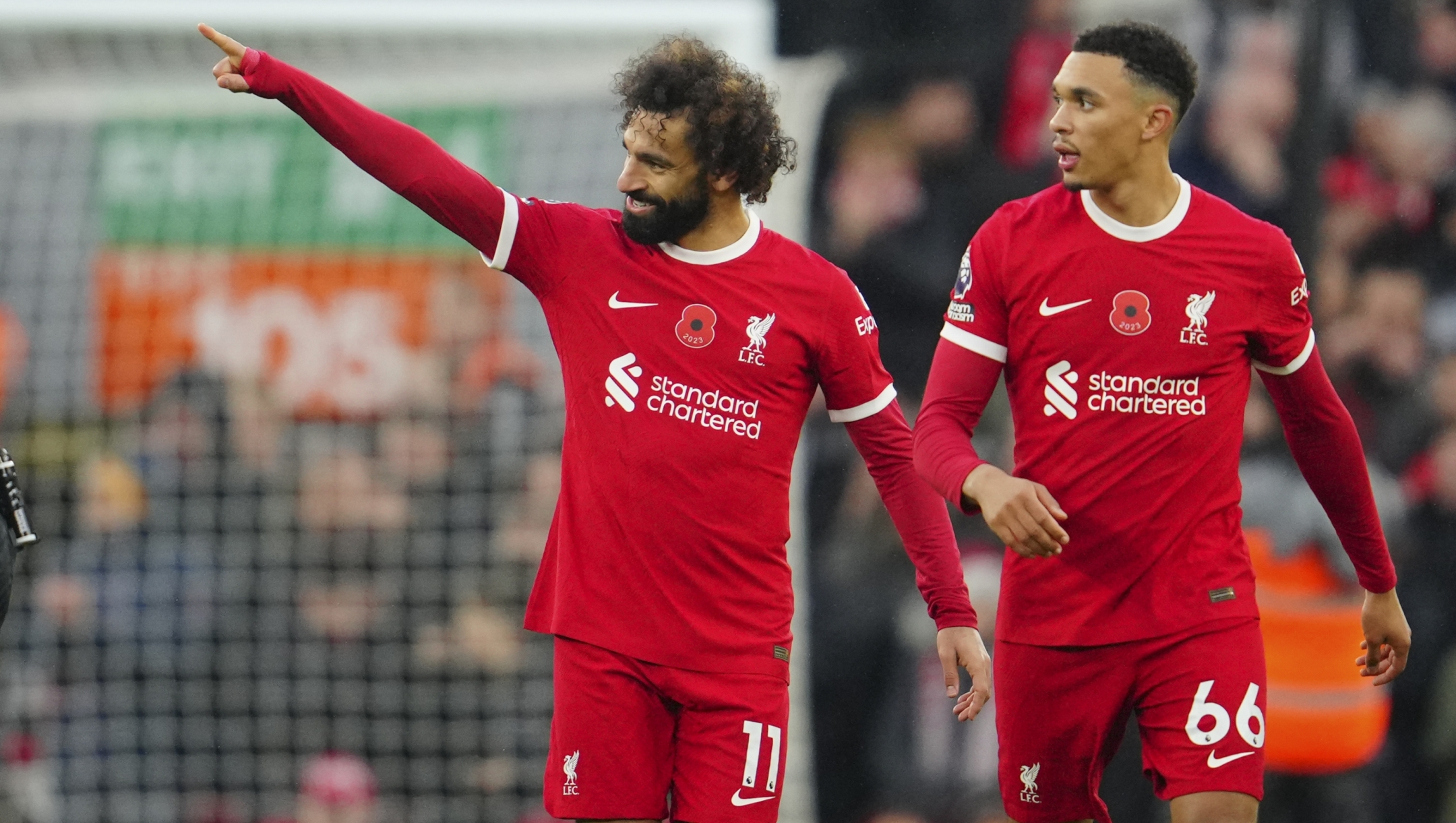 Liverpool's Mohamed Salah, left, celebrates scoring his side's 2nd goal next to teammate Trent Alexander-Arnold during the English Premier League soccer match between Liverpool and Brentford at Anfield stadium in Liverpool, England, Sunday, Nov. 12, 2023. (AP Photo/Jon Super)