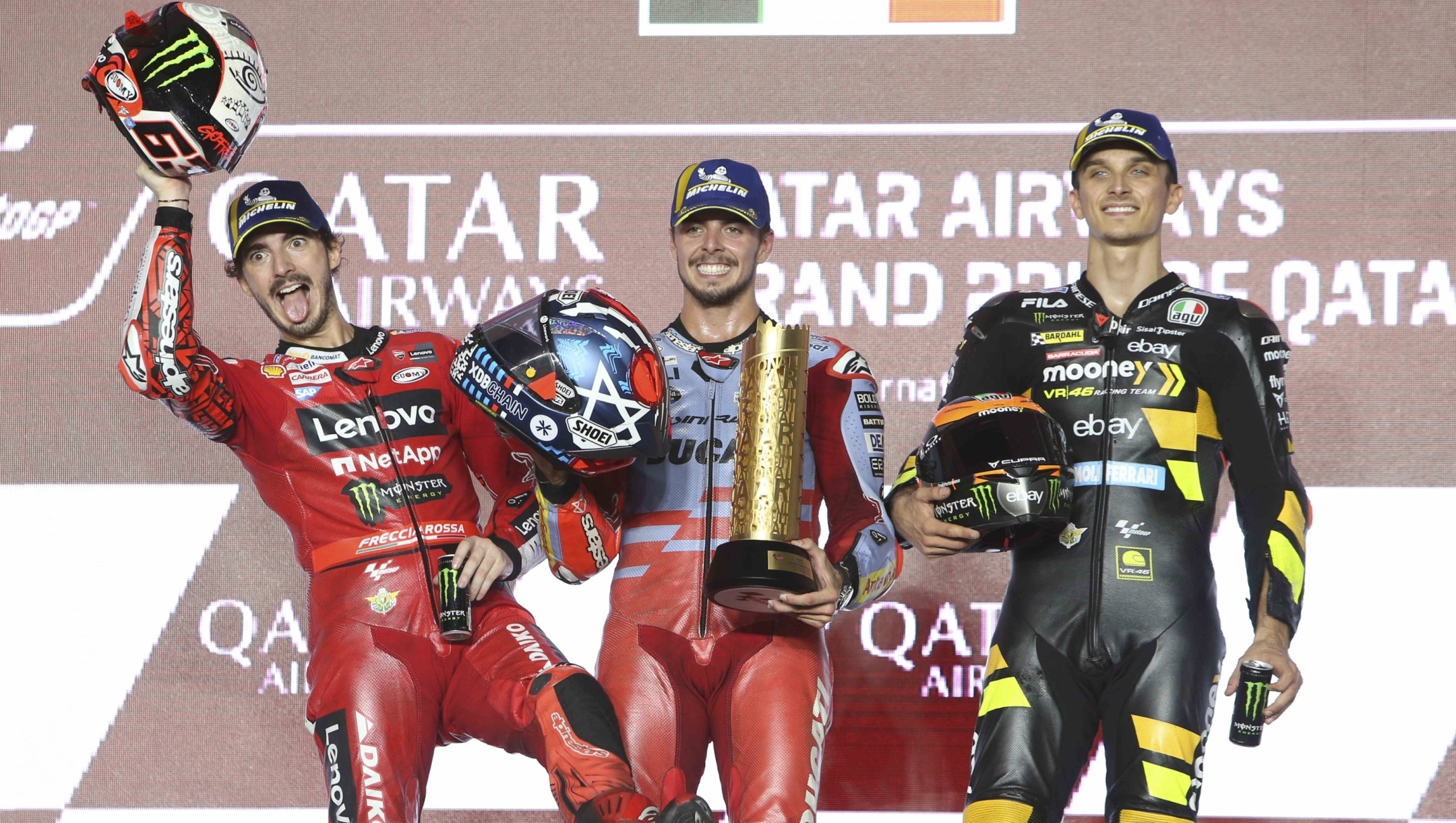 First place, Ducati rider Fabio Di Giannantonio, of Italy, center, second placed, Ducati rider Francesco Bagnaia, of Italy, left, and third placed, Ducati rider Luca Marini, of Italy, celebrate on the podium end of the Qatari MotoGP Grand Prix at the Lusail International Circuit in Lusail, Qatar, Sunday, Nov. 19, 2023. (AP Photo/Hussein Sayed)   Associated Press/LaPresse Only Italy and Spain
