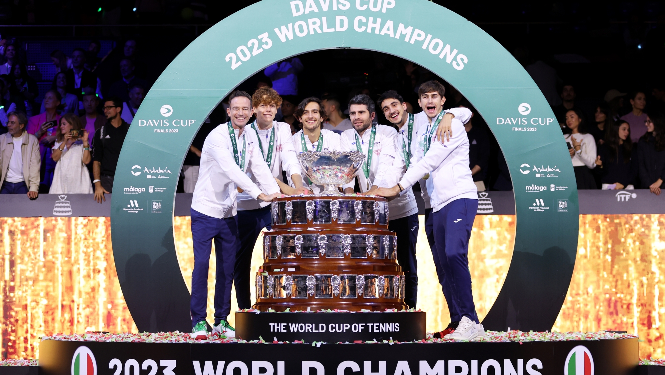 MALAGA, SPAIN - NOVEMBER 26: Filippo Volandri, Jannik Sinner, Lorenzo Musetti, Matteo Arnaldi, Lorenzo Sonego and Simone Bolelli of Italy celebrate with the Davis Cup Trophy after their teams victory during the Davis Cup Final match against Australia at Palacio de Deportes Jose Maria Martin Carpena on November 26, 2023 in Malaga, Spain. (Photo by Clive Brunskill/Getty Images for ITF)