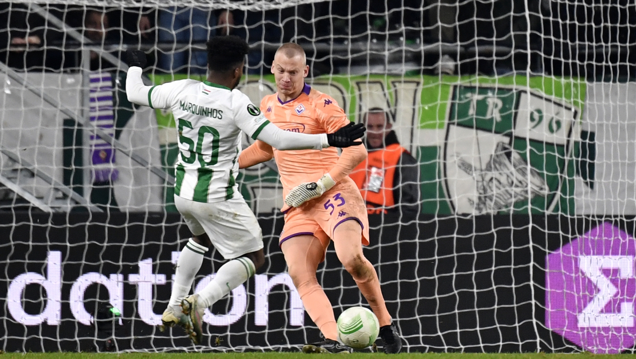 Fiorentina goalkeeper Oliver Christensen makes a save in front of Ferencvaros' Marquinhos during the Europa Conference League group F soccer match between Ferencvaros and Fiorentina at the Ferencvaros Stadion in Budapest, Thursday, Dec. 14, 2023. (AP Photo/Denes Erdos)
