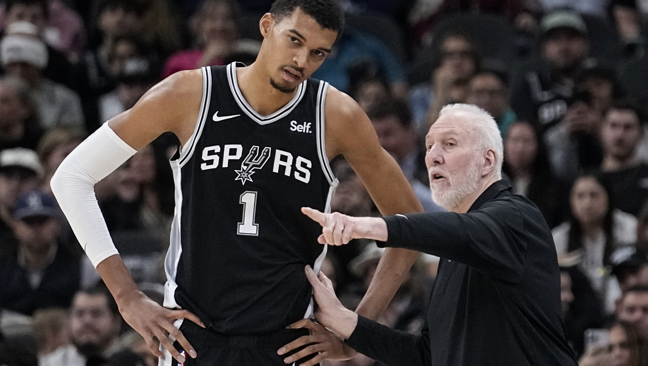 San Antonio Spurs head coach Gregg Popovich, right, talks with center Victor Wembanyama (1) during the first half of an NBA basketball game against the Los Angeles Lakers in San Antonio, Wednesday, Dec. 13, 2023. (AP Photo/Eric Gay)