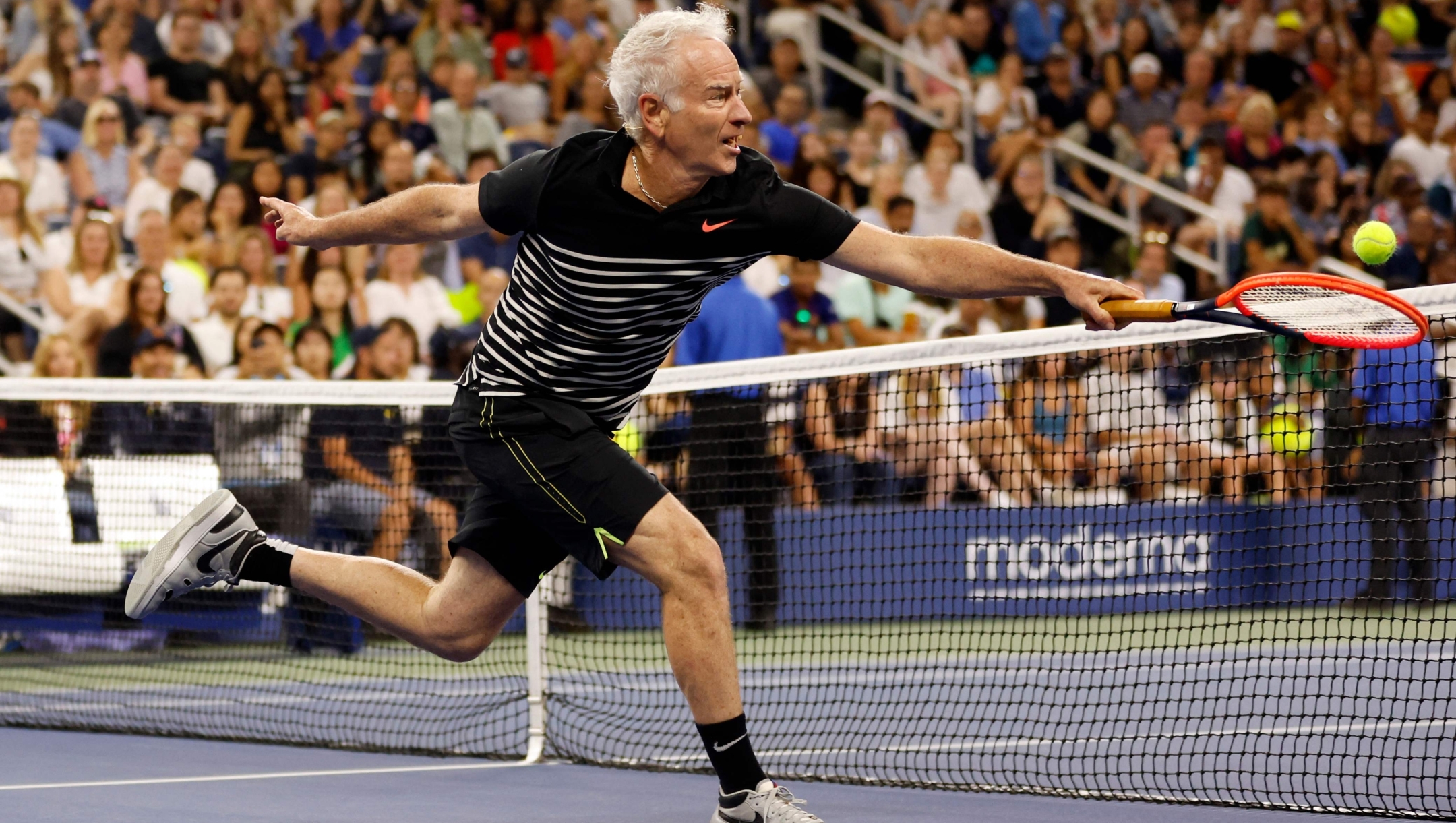 NEW YORK, NEW YORK - AUGUST 23: Former tennis player John McEnroe of the United States returns a shot while playing in the Stars of the Open Exhibition Match to Benefit Ukraine Relief prior to the 2023 US Open at USTA Billie Jean King National Tennis Center on August 23, 2023 in New York City.   Sarah Stier/Getty Images/AFP (Photo by Sarah Stier / GETTY IMAGES NORTH AMERICA / Getty Images via AFP)