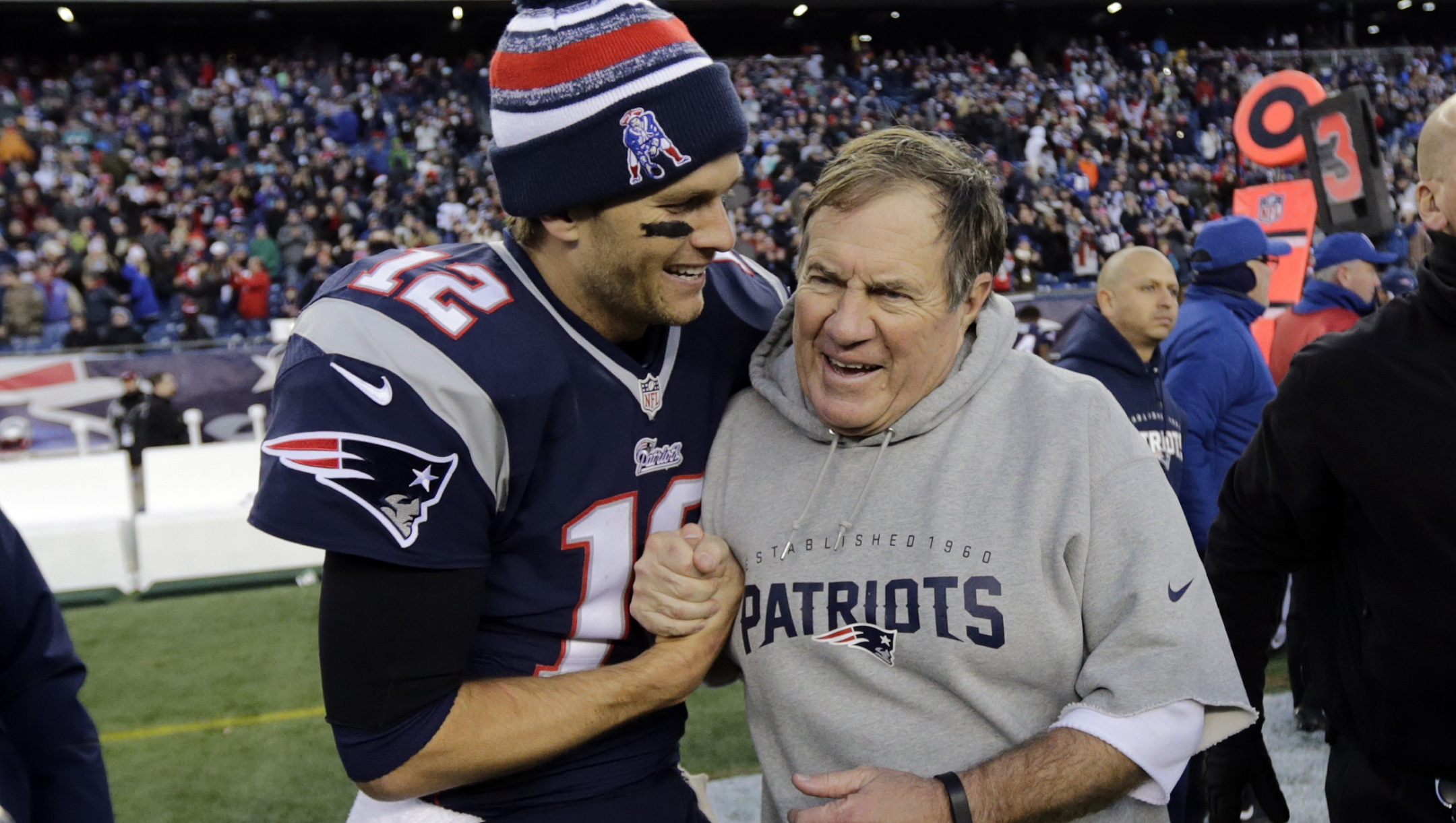 FILE - New England Patriots quarterback Tom Brady, left, celebrates with head coach Bill Belichick after defeating the Miami Dolphins 41-13 in an NFL football game Sunday, Dec. 14, 2014, in Foxborough, Mass. Six-time NFL champion Bill Belichick has agreed to part ways as the coach of the New England Patriots on Thursday, Jan. 11, 2024, bringing an end to his 24-year tenure as the architect of the most decorated dynasty of the league?s Super Bowl era, a source told the Associated Press on the condition of anonymity because it has not yet been announced.  (AP Photo/Charles Krupa, File)