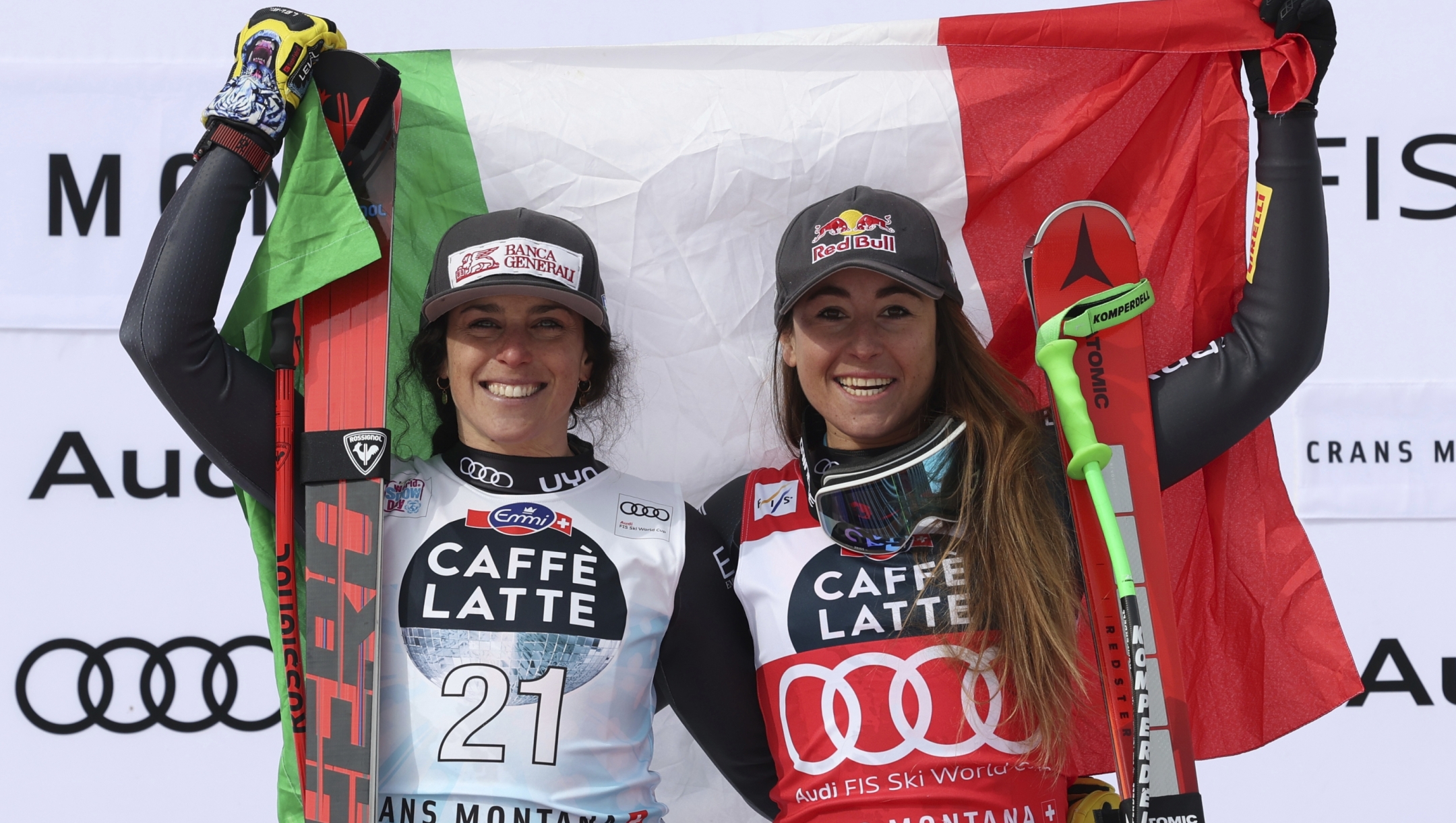 From left, second placed Italy's Federica Brignone and the winner Italy's Sofia Goggia celebrate after completing an alpine ski, women's World Cup downhill race in Crans Montana, Switzerland, Sunday, Feb. 26, 2023. (AP Photo/Alessandro Trovati)