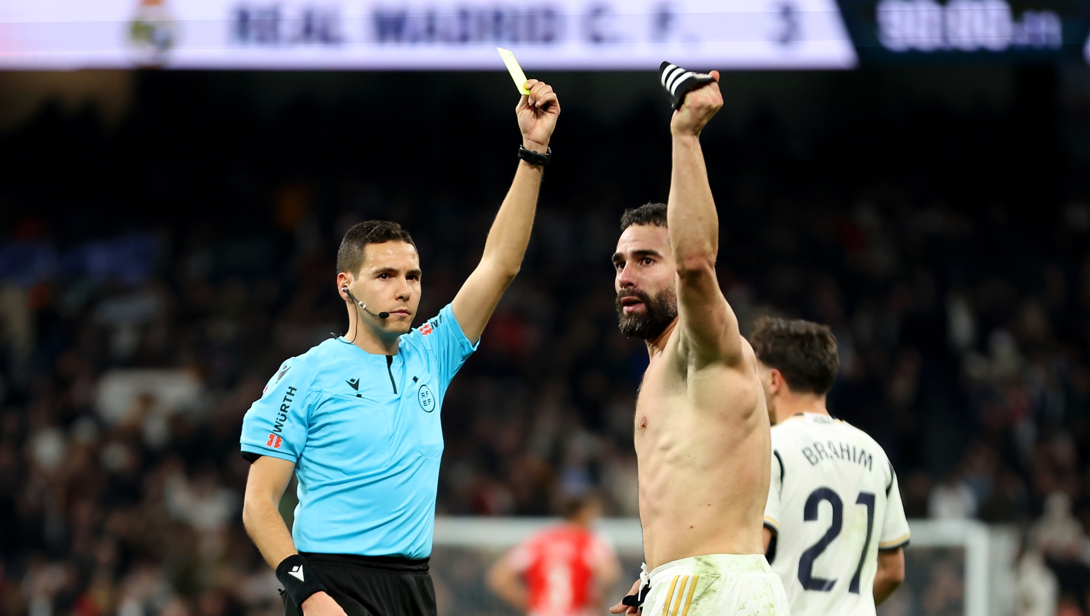 MADRID, SPAIN - JANUARY 21: Referee Francisco José Hernández Maeso gives Daniel Carvajal of Real Madrid a yellow card for his celebration after scoring the teams third goal during the LaLiga EA Sports match between Real Madrid CF and UD Almeria at Estadio Santiago Bernabeu on January 21, 2024 in Madrid, Spain. (Photo by Florencia Tan Jun/Getty Images)