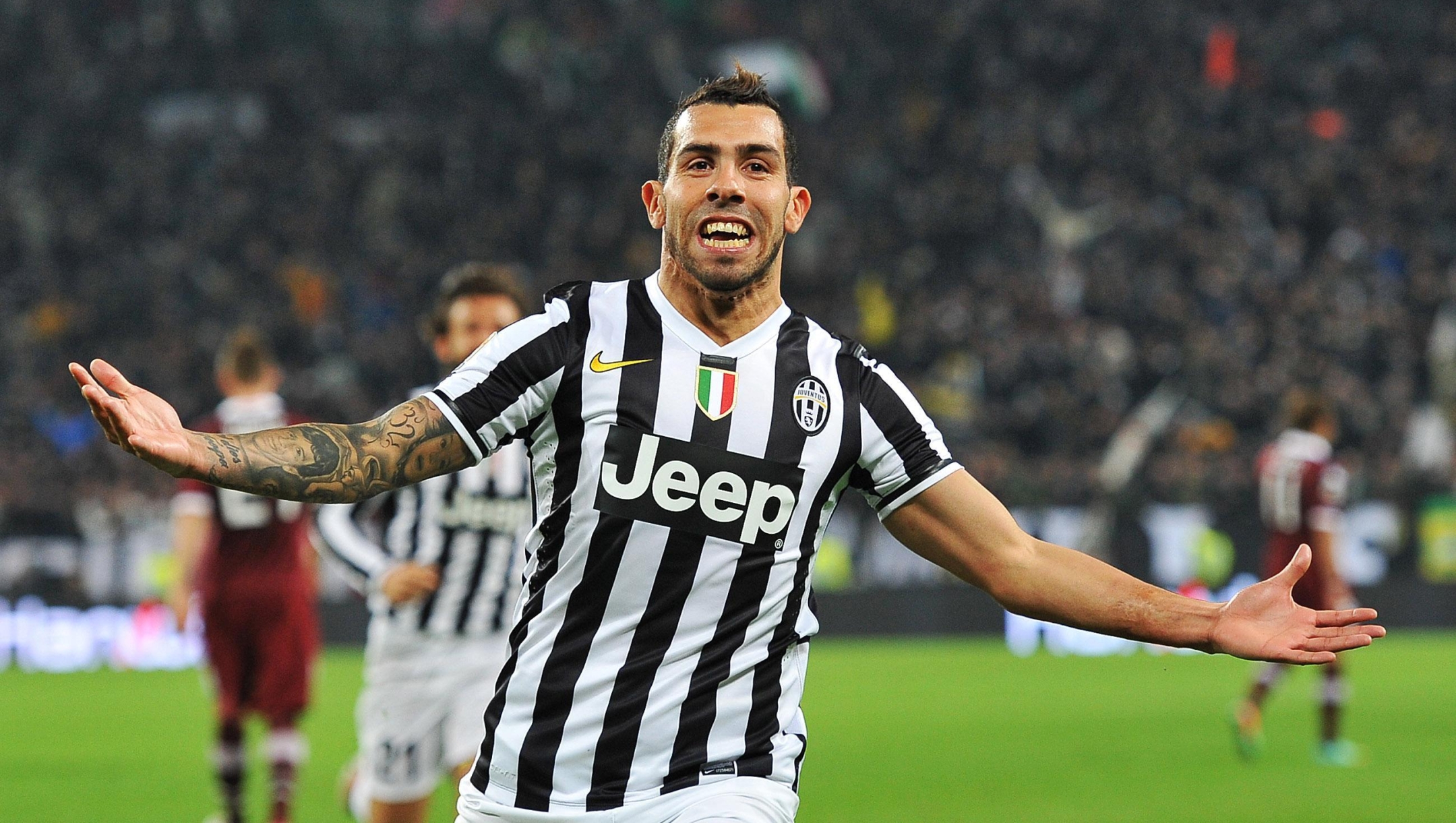 Argentinian forward of Juventus Fc Carlos Tevez celebrates after scoring the 1-0 goal lead during Italian Serie A soccer match between Juventus Fc and Torino Fc at the Juventus Stadium, Turin, 23 February 2014. ANSA/DI MARCO