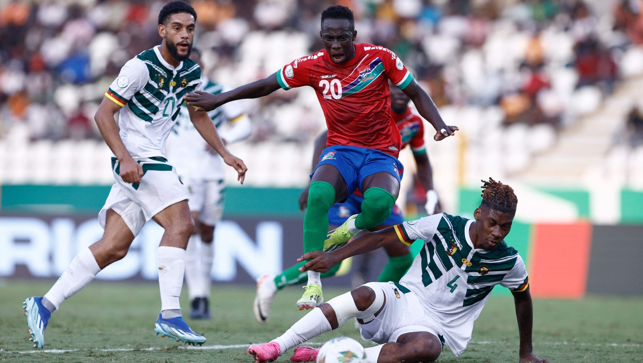 Cameroon's defender #4 Christopher Wooh fights for the ball with Gambia's forward #20 Yankuba Minteh during the Africa Cup of Nations (CAN) 2024 group C football match between Gambia and Cameroon at Stade de la Paix in Bouake on January 23, 2024. (Photo by KENZO TRIBOUILLARD / AFP)