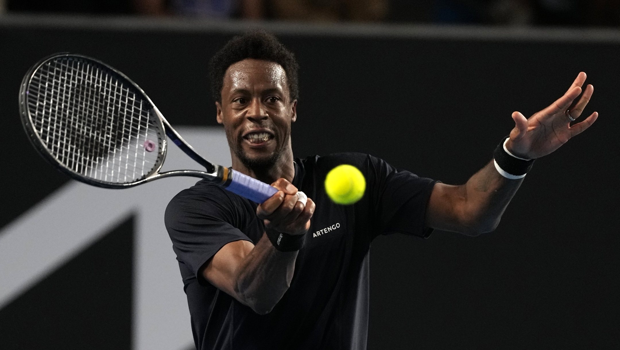 Gael Monfils of France plays a forehand return to Tomas Martin Etcheverry of Argentina during their second round match at the Australian Open tennis championships at Melbourne Park, Melbourne, Australia, Wednesday, Jan. 17, 2024. (AP Photo/Louise Delmotte)
