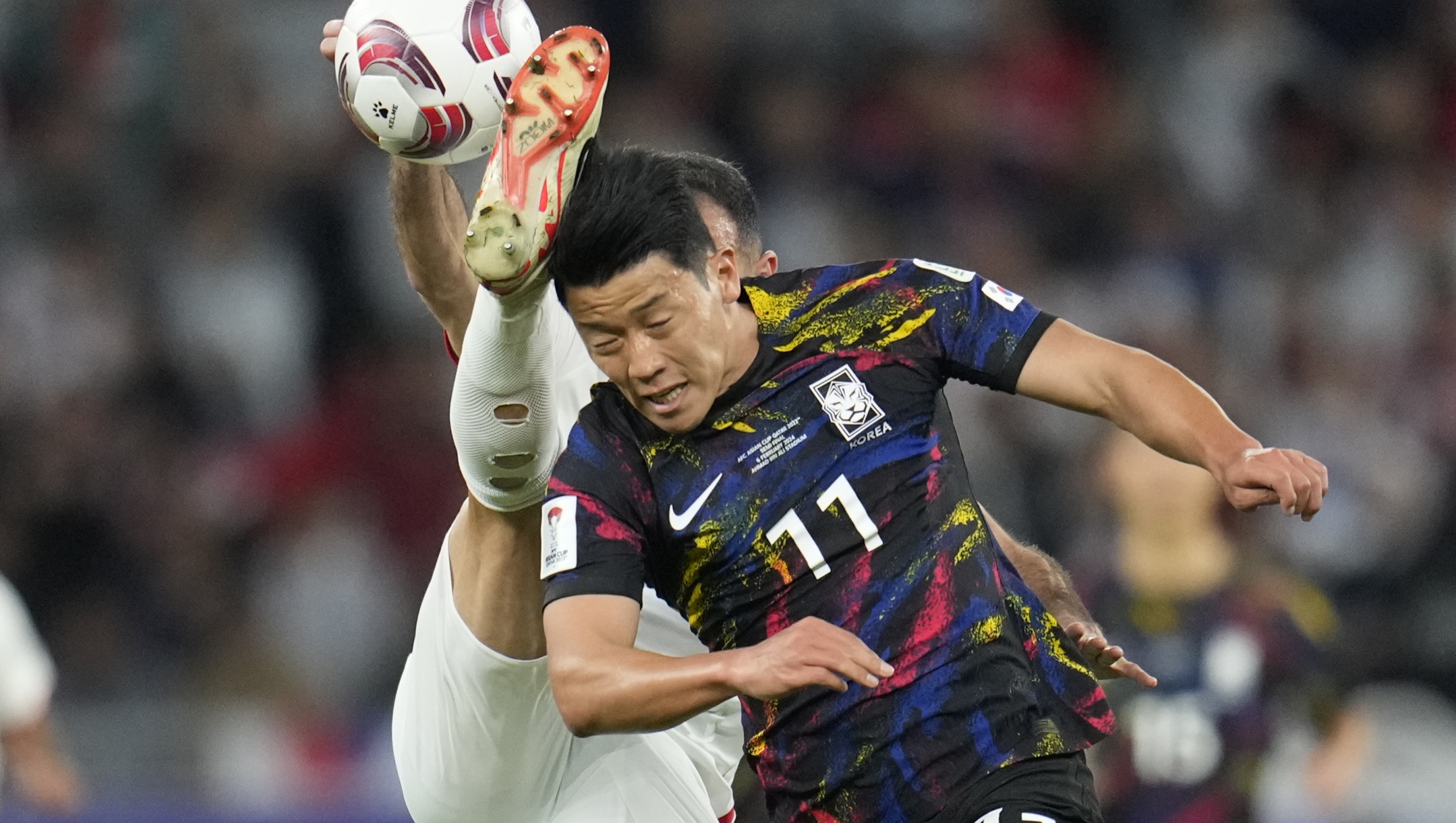 South Korea's Hwang Hee-chan, right, and Jordan's Ehsan Haddad vie for the ball during the Asian Cup semifinal soccer match between South Korea and Jordan at Ahmad Bin Ali Stadium in Al Rayyan, Qatar, Tuesday, Feb. 6, 2024. (AP Photo/Aijaz Rahi)