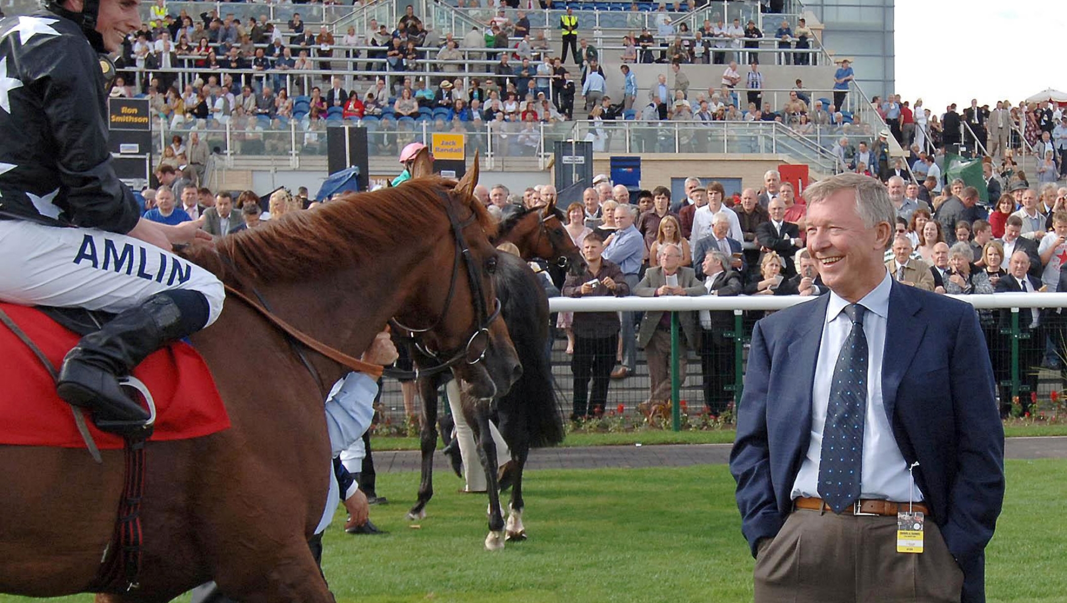 Sir Alex Ferguson, the manager of English Premier League soccer Champions Manchester United, talks with his jockey Ryan Moore after his horse Broomielaw won the Pennine Express Maiden Stakes at Doncaster racecourse, England, Friday Aug. 17, 2007. (AP Photo/PA, John Giles) ** UNITED KINGDOM OUT NO SALES NO ARCHIVE **
