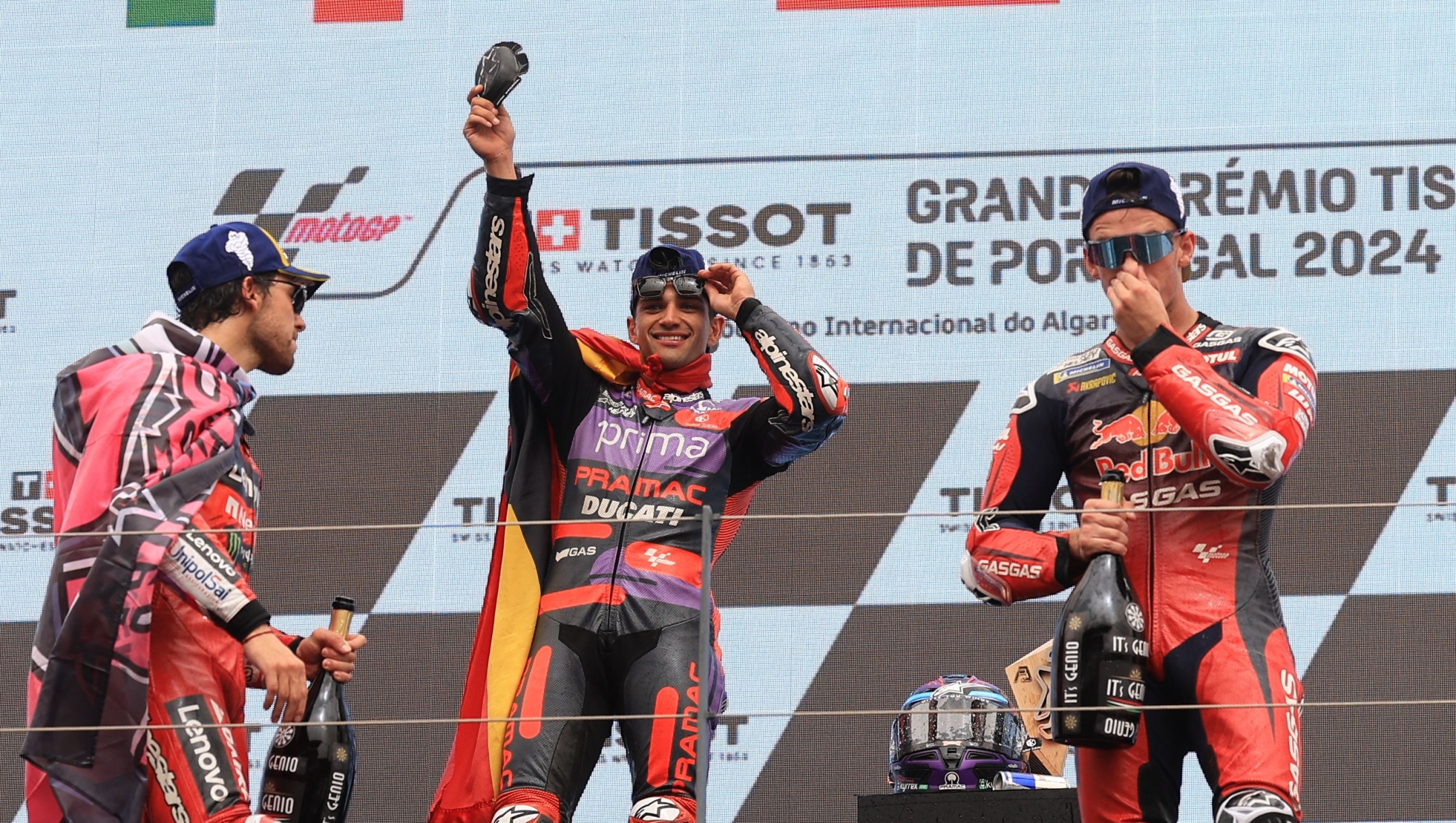 Ducati Spanish rider Jorge Martin (C) celebrates on the podium with second placed Ducati Italian rider Enea Bastianini (L) and third placed KTM Spanish rider Pedro Acosta after winning the MotoGP race of the Portuguese Grand Prix at the Algarve International Circuit in Portimao on March 24, 2024. (Photo by PATRICIA DE MELO MOREIRA / AFP)