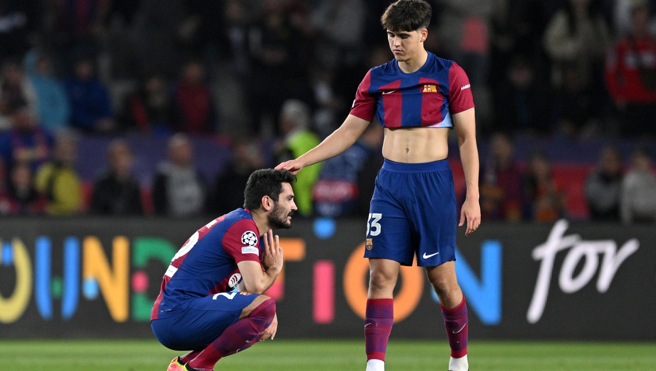 BARCELONA, SPAIN - APRIL 16: Ilkay Guendogan of FC Barcelona is consoled by teammate Pau Cubarsi after the team's defeat in the UEFA Champions League quarter-final second leg match between FC Barcelona and Paris Saint-Germain at Estadi Olimpic Lluis Companys on April 16, 2024 in Barcelona, Spain. (Photo by David Ramos/Getty Images)
