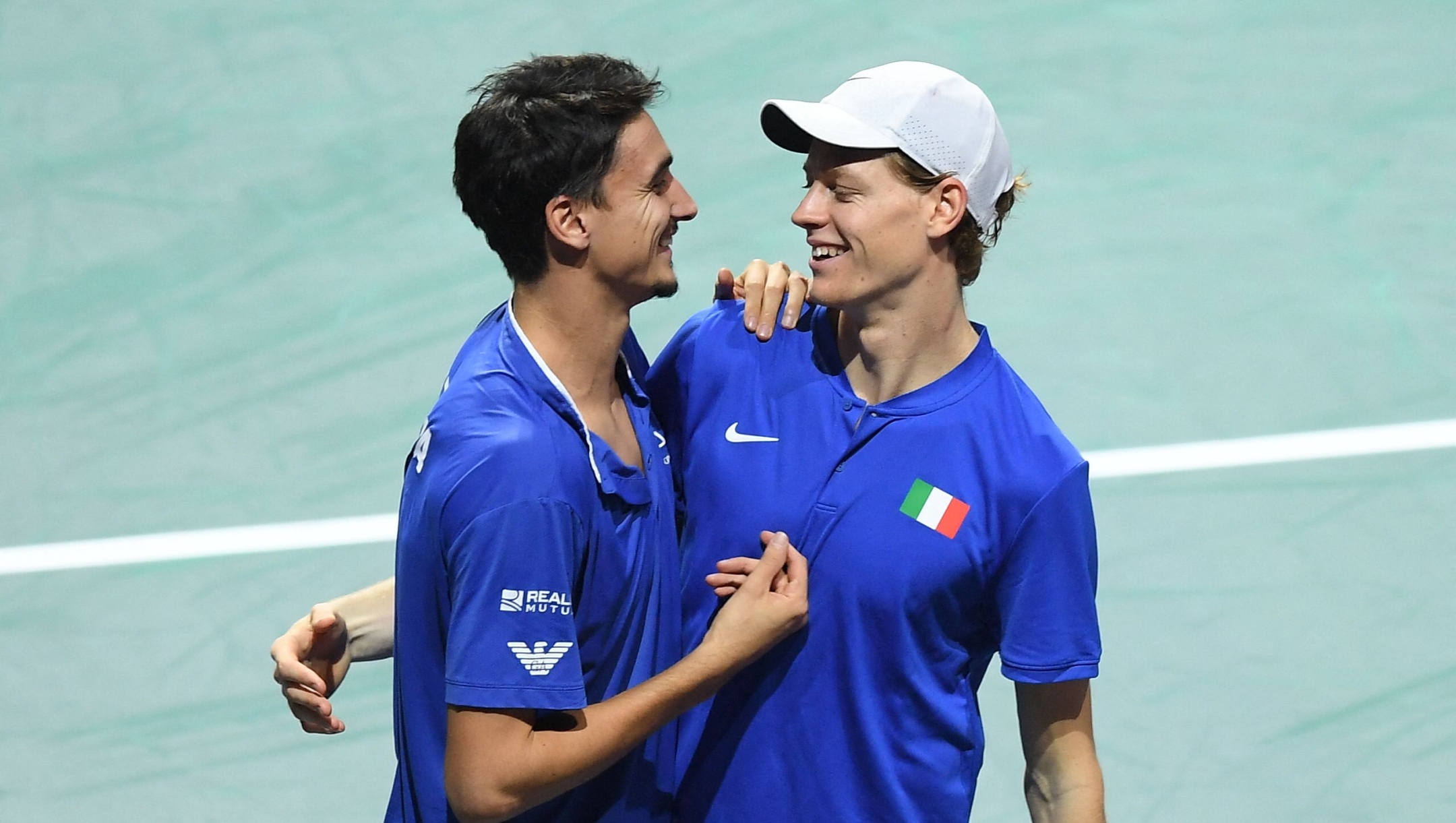 Italy's Jannik Sinner (R) and Lorenzo Sonego celebrate after winning against Serbia's Novak Djokovic and Momir Kecmanovic during the men's doubles semifinal tennis match between Italy and Serbia of the Davis Cup tennis tournament at the Martin Carpena sportshall, in Malaga on November 25, 2023. (Photo by JORGE GUERRERO / AFP)