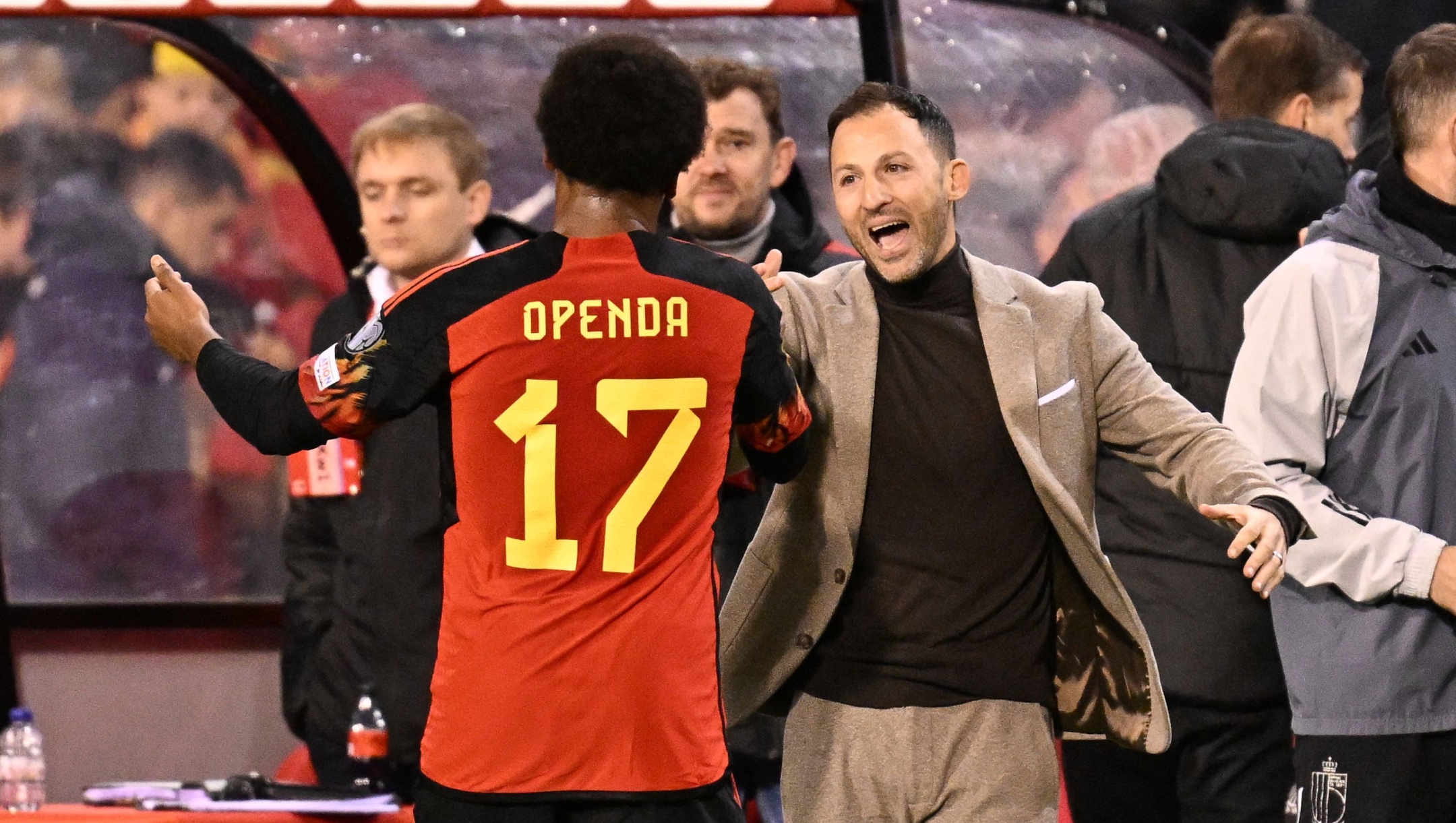 Belgium's midfielder #17 Lois Openda (CL) celebrates with Belgium's head coach Domenico Tedesco (CR) after winning the UEFA Champions League Qualifying Group F football match between Belgium and Azerbaijan at The King Baudouin Stadium in Brussels, on November 19, 2023. (Photo by JOHN THYS / AFP)