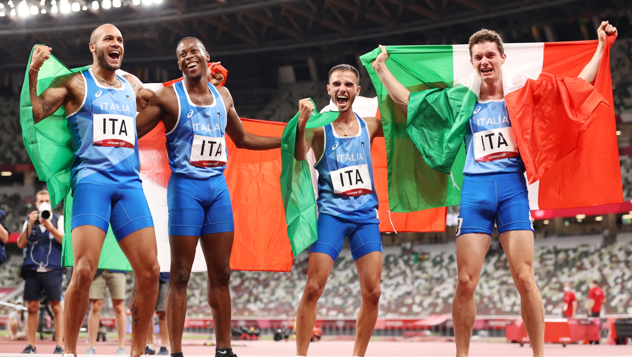 TOKYO, JAPAN - AUGUST 06: Lorenzo Patta, Lamont Marcell Jacobs, Eseosa Fostine Desalu and Filippo Tortu of Team Italy celebrate winning the gold medal in the Men's 4 x 100m Relay Final on day fourteen of the Tokyo 2020 Olympic Games at Olympic Stadium on August 06, 2021 in Tokyo, Japan. (Photo by David Ramos/Getty Images)