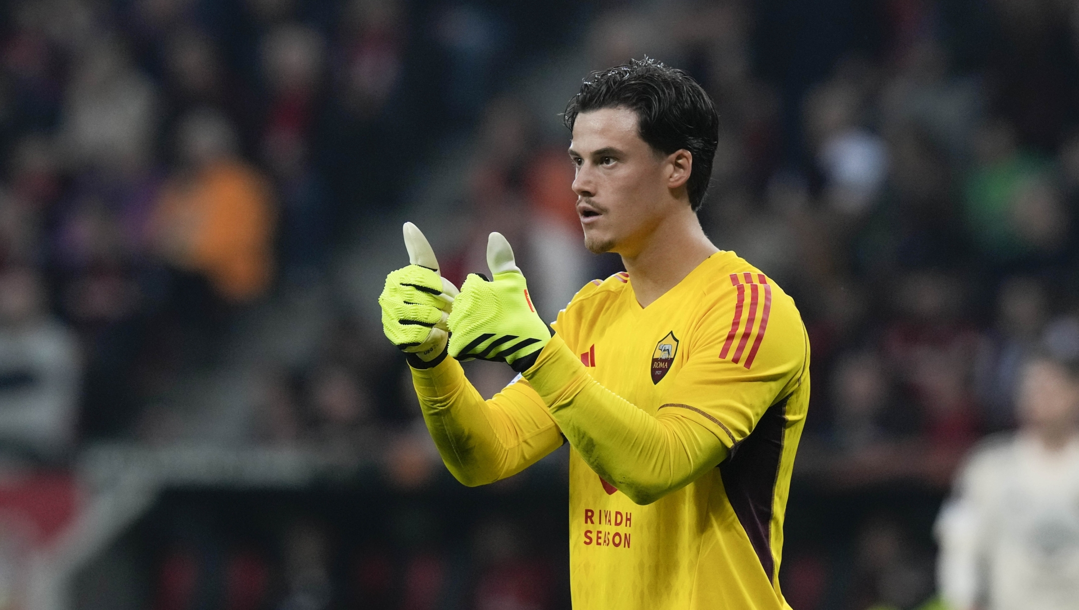 Roma's goalkeeper Mile Svilar gestures during the Europa League second leg semi-final soccer match between Leverkusen and Roma at the BayArena in Leverkusen, Germany, Thursday, May 9, 2024. (AP Photo/Matthias Schrader)