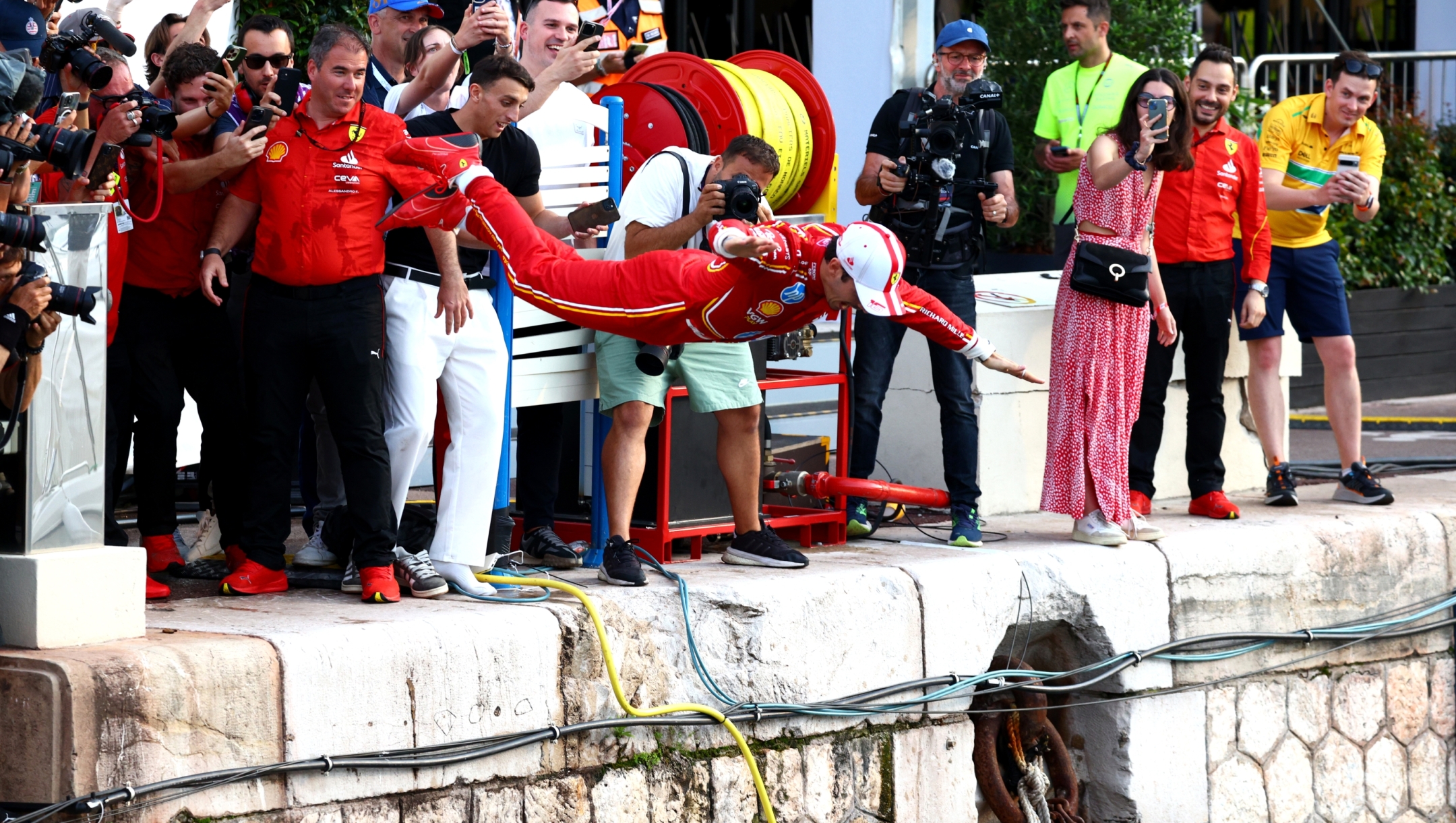 MONTE-CARLO, MONACO - MAY 26: Race winner Charles Leclerc of Monaco and Ferrari celebrates by jumping in the harbour after the F1 Grand Prix of Monaco at Circuit de Monaco on May 26, 2024 in Monte-Carlo, Monaco. (Photo by Clive Rose/Getty Images)