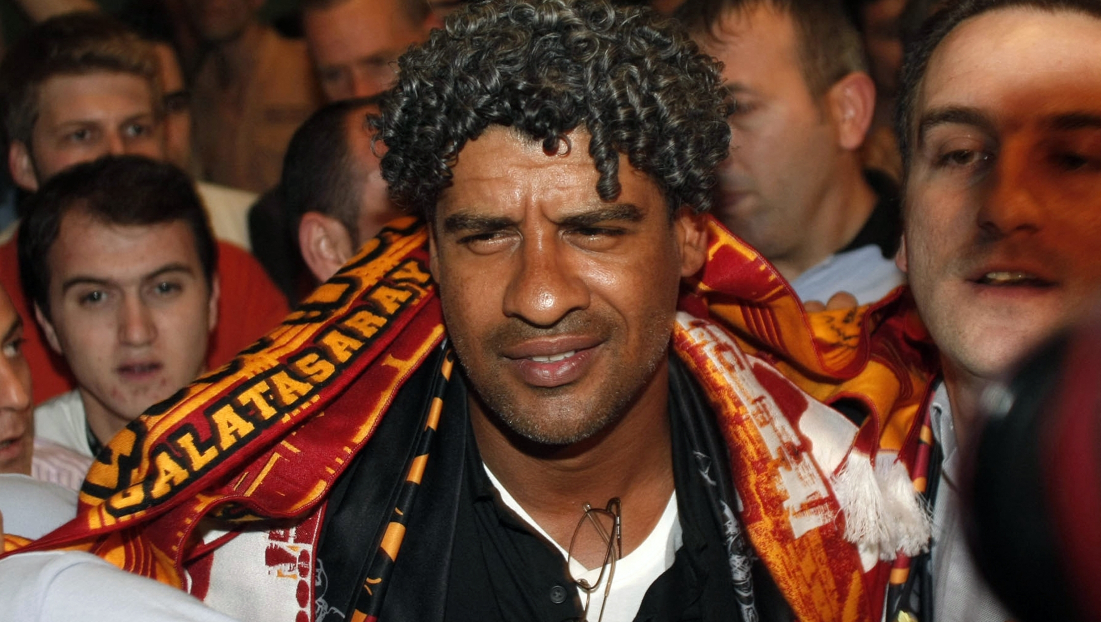 Dutch soccer coach Frank Rijkaard (C) is welcomed by Galatasaray soccer fans upon his arrival at Ataturk airport in Istanbul on June 5, 2009. Rijkaard will replace Bulent Korkmaz as coach at Galatasaray, the Turkish club said on Friday. AFP PHOTO/STR (Photo by AFP)