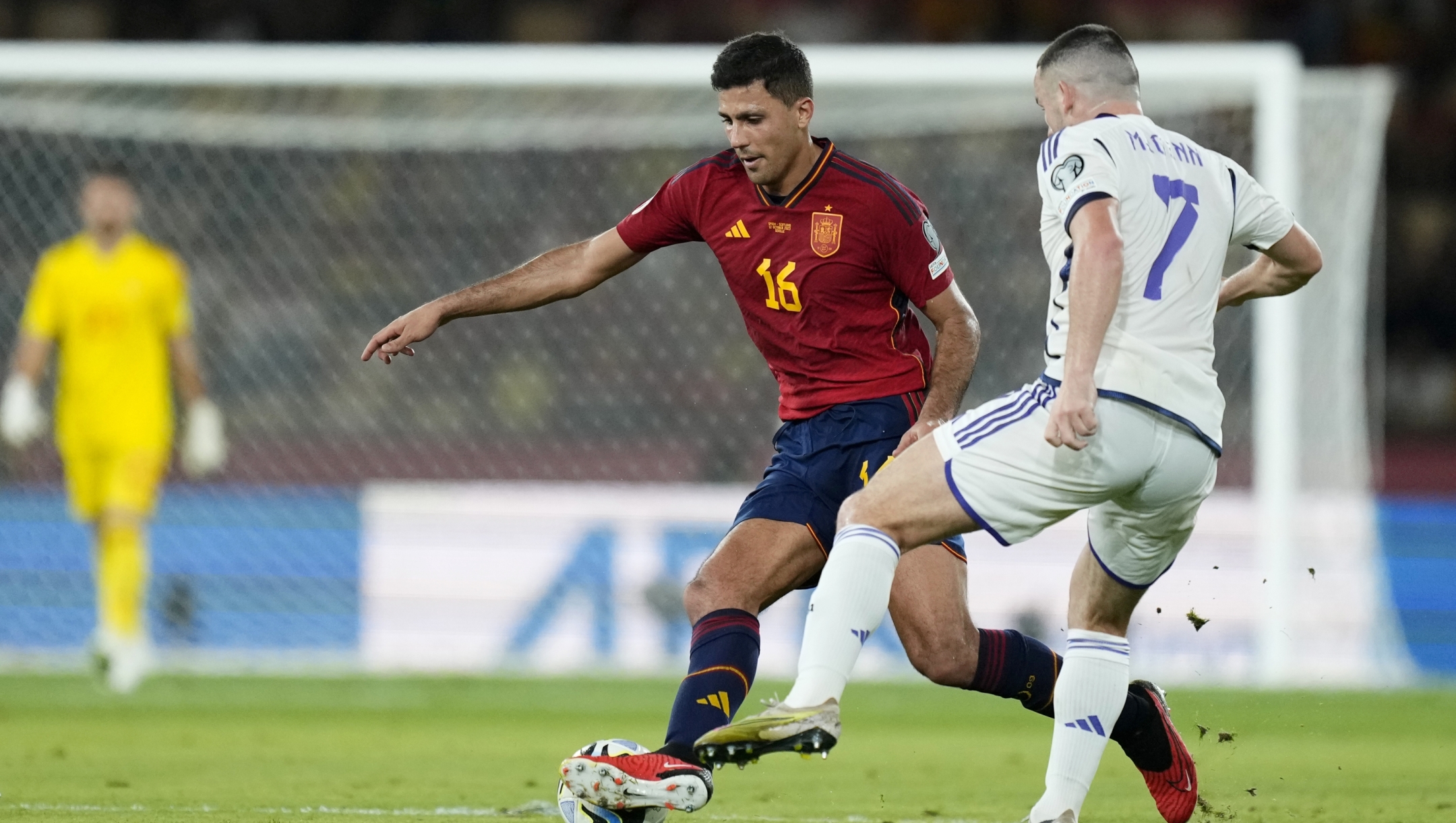 Spain's Rodri tries to dribble the ball past Scotland's John McGinn, right, during the Euro 2024 group A qualifying soccer match between Spain and Scotland at La Cartuja stadium in Seville, Spain, Thursday, Oct. 12, 2023. (AP Photo/Jose Breton)