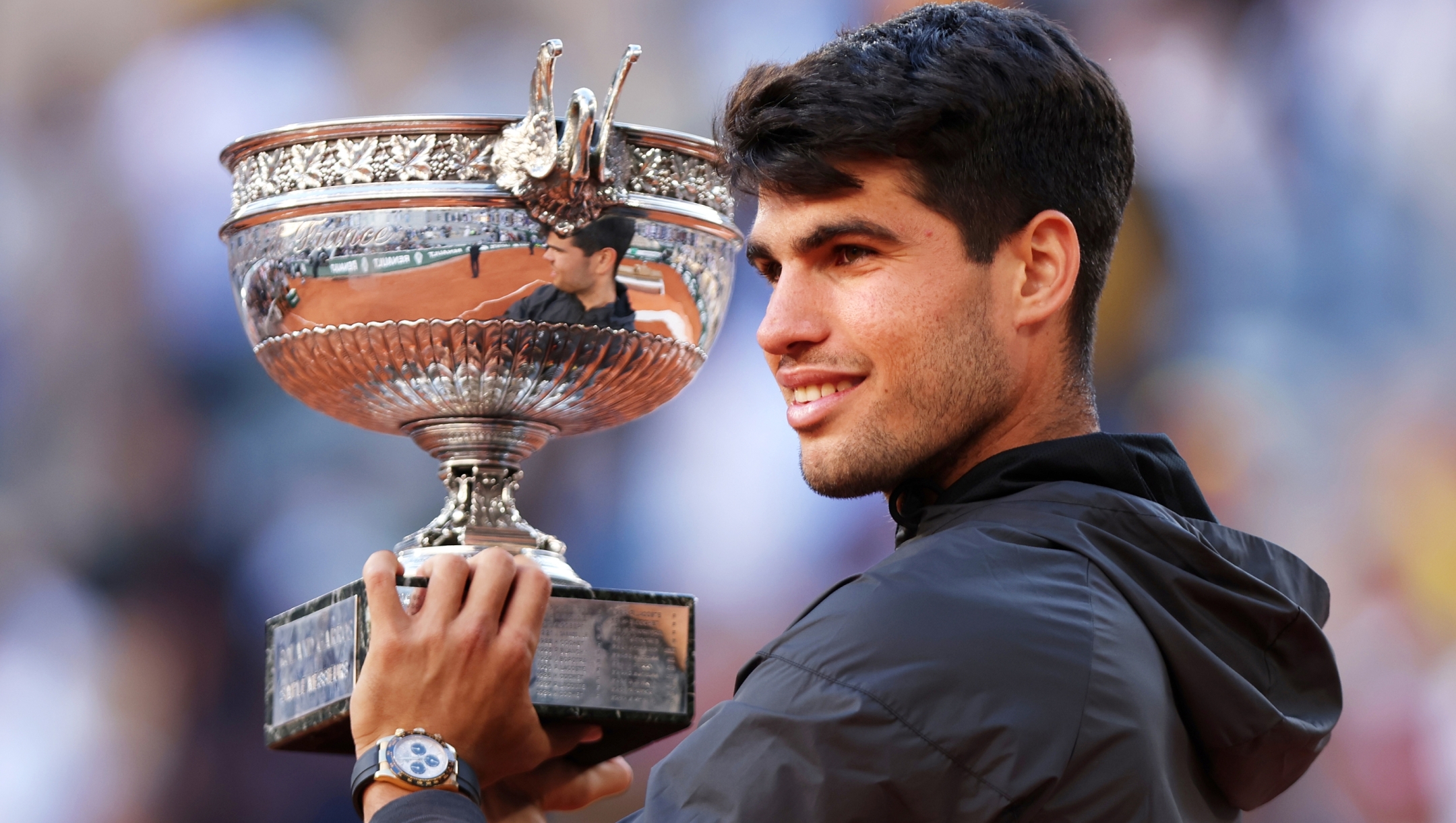 PARIS, FRANCE - JUNE 09: Carlos Alcaraz of Spain celebrates with the winners trophy after victory in the Men's Singles Final match between Alexander Zverev of Germany and Carlos Alcaraz of Spain on Day 15 of the 2024 French Open at Roland Garros on June 09, 2024 in Paris, France. (Photo by Dan Istitene/Getty Images)