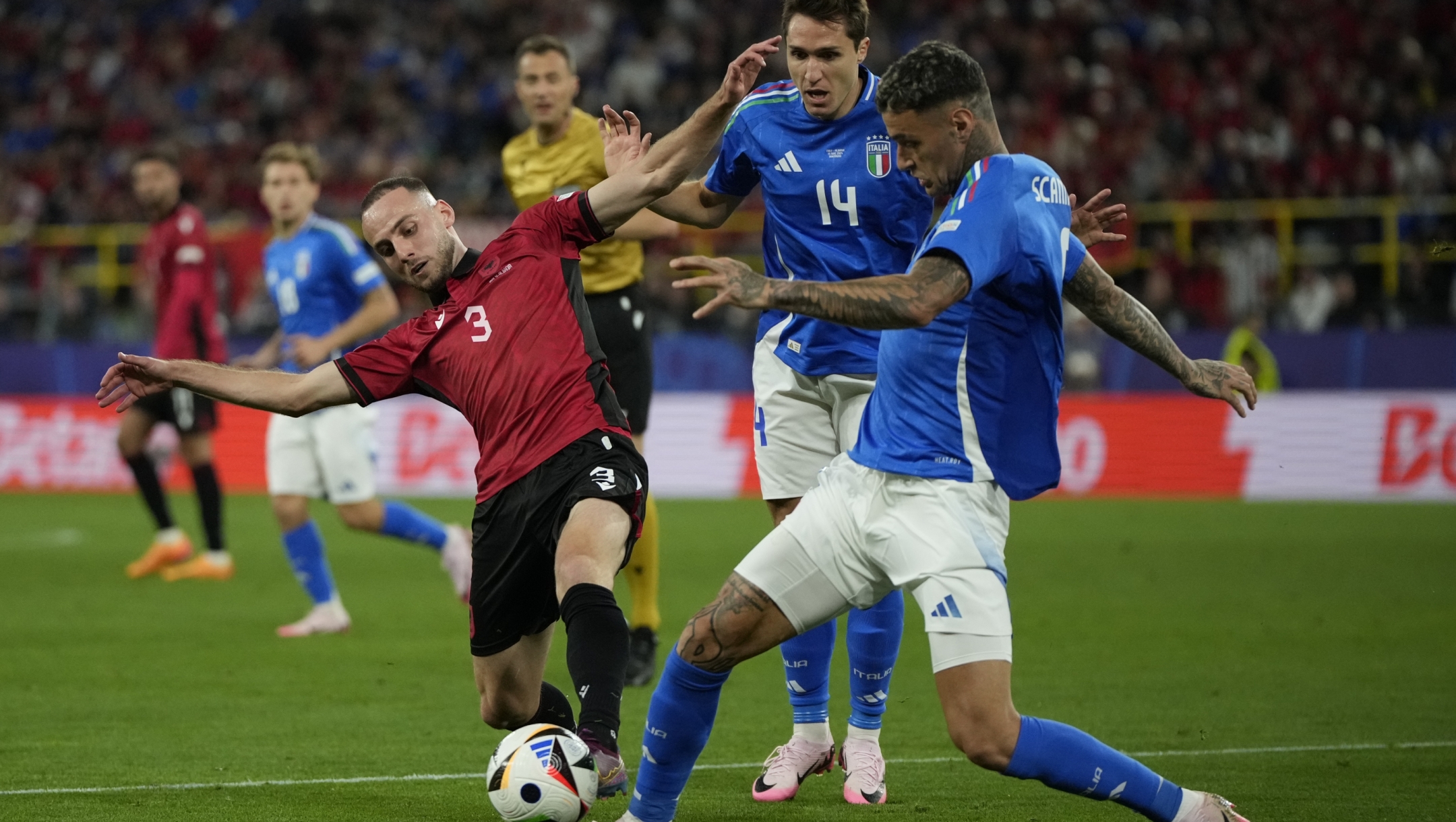Albania's Mario Mitaj, left, fights for the ball with Italy's Federico Chiesa, center, and Italy's Gianluca Scamacca during a Group B match between Italy and Albania at the Euro 2024 soccer tournament in Dortmund, Germany, Saturday, June 15, 2024. (AP Photo/Alessandra Tarantino)
