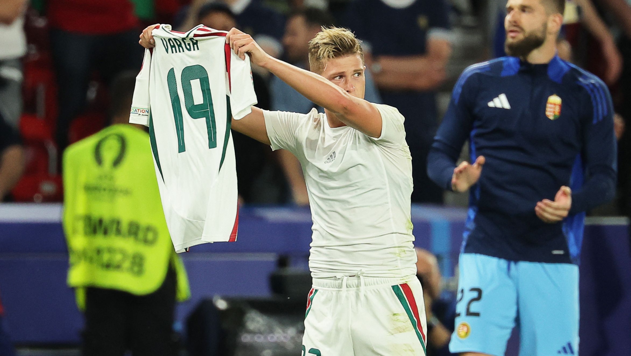 Hungary's forward #23 Kevin Csoboth holds Hungary's forward #19 Barnabas Varga's jersey to celebrate scoring his team's first goal during the UEFA Euro 2024 Group A football match between Scotland and Hungary at the Stuttgart Arena in Stuttgart on June 23, 2024. (Photo by LLUIS GENE / AFP)