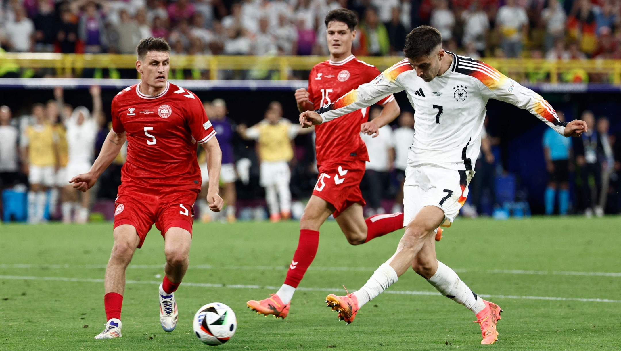 Germany's forward #07 Kai Havertz shoots the ball past Denmark's defender #05 Joakim Maehle and midfielder #15 Christian Norgaard during the UEFA Euro 2024 round of 16 football match between Germany and Denmark at the BVB Stadion Dortmund in Dortmund on June 29, 2024. (Photo by KENZO TRIBOUILLARD / AFP)