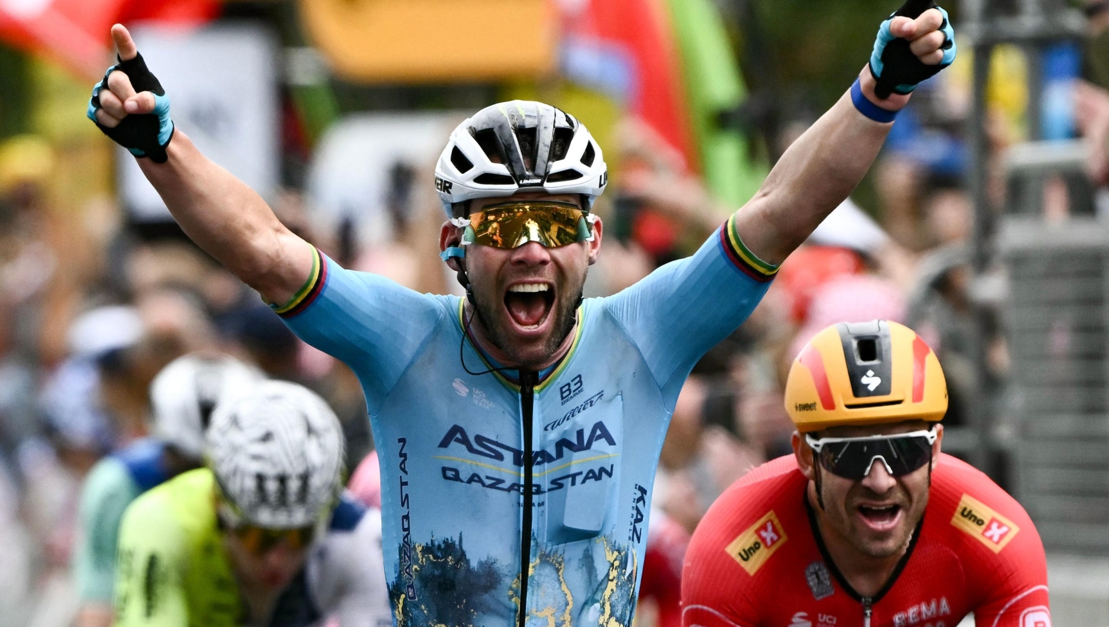 TOPSHOT - Astana Qazaqstan Team's British rider Mark Cavendish (C) cycles past the finish line ahead of third-placed Uno-X Mobility team's Norwegian rider Alexander Kristoff (R) to win the 5th stage of the 111th edition of the Tour de France cycling race, 177,5 km between Saint-Jean-de-Maurienne and Saint-Vulbas, his 35th Tour de France stage victory beating the previous record held by Belgian rider Eddy Merckx, on July 3, 2024. (Photo by Marco BERTORELLO / AFP)