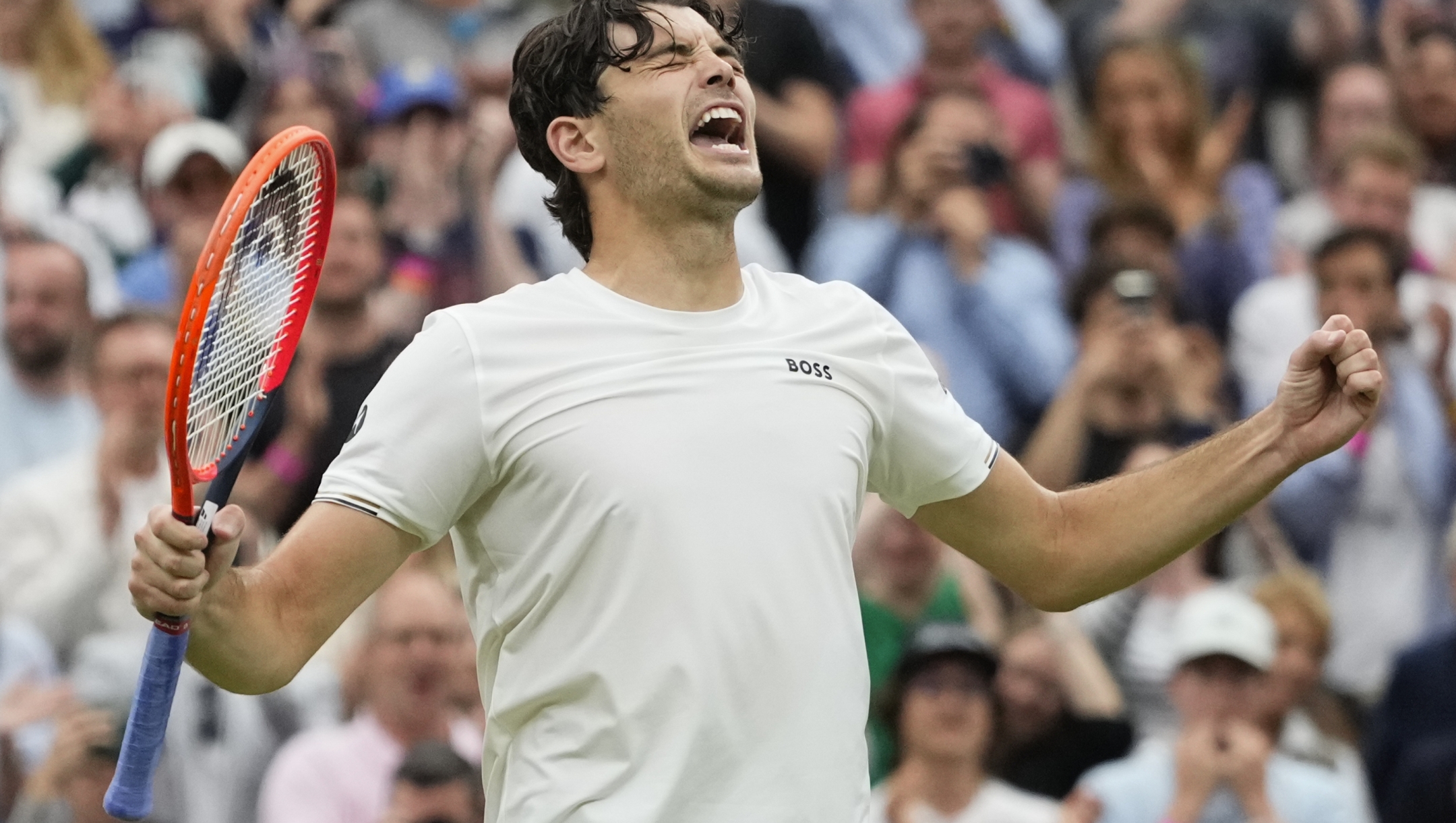 Taylor Fritz of the United States celebrates after defeating Alexander Zverev of Germany in their fourth round match at the Wimbledon tennis championships in London, Monday, July 8, 2024. (AP Photo/Kirsty Wigglesworth)