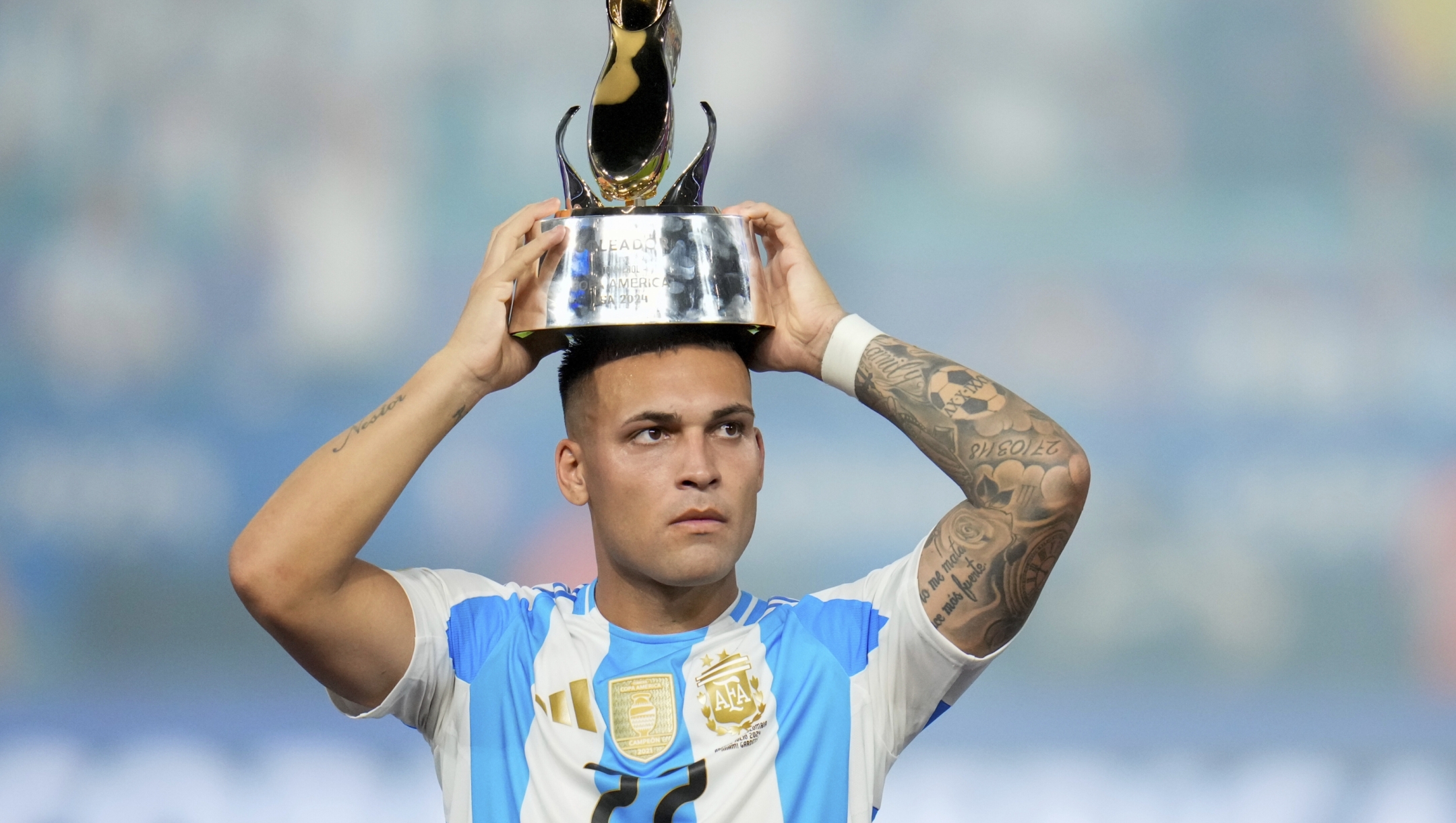 Argentina's Lautaro Martínez celebrates with the Golden Boot trophy after defeating Colombia in the Copa America final soccer match in Miami Gardens, Fla., Monday, July 15, 2024. (AP Photo/Julio Cortez)