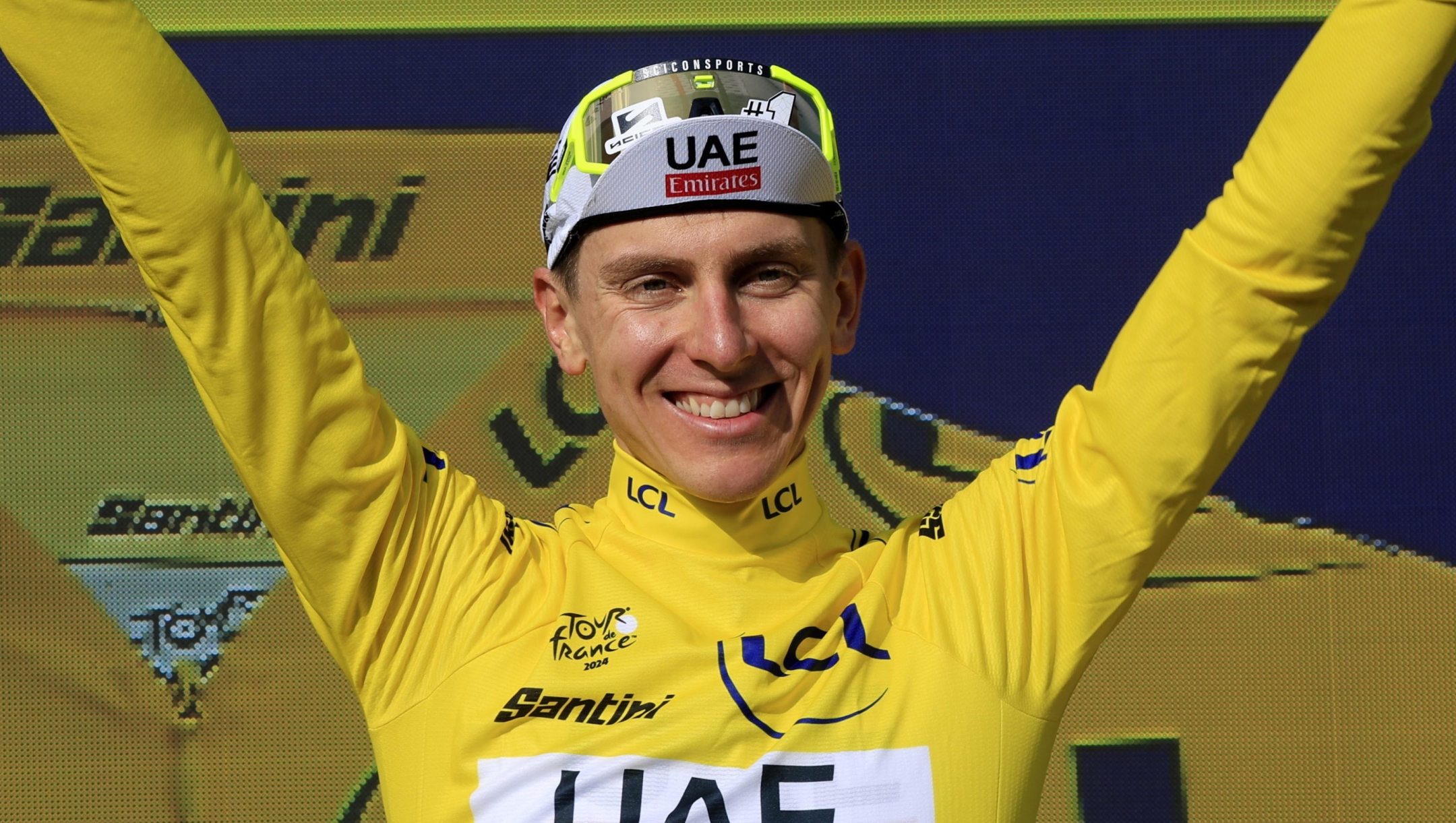 epa11489481 Slovenian rider Tadej Pogacar of UAE Team Emirates celebrates in the overall leader's yellow jersey on the podium after winning the 20th stage of the 2024 Tour de France cycling race over 132km from Nice to Col de la Couillole, France, 20 July 2024.  EPA/GUILLAUME HORCAJUELO